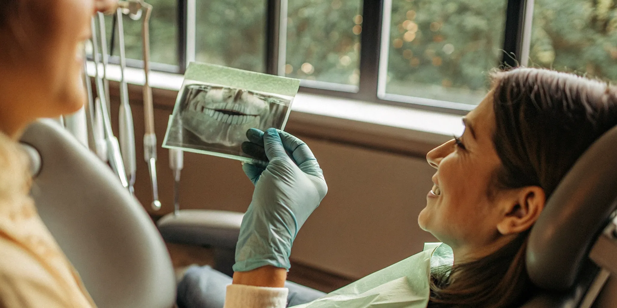 Dentist reviewing a dental X-ray with a relaxed patient