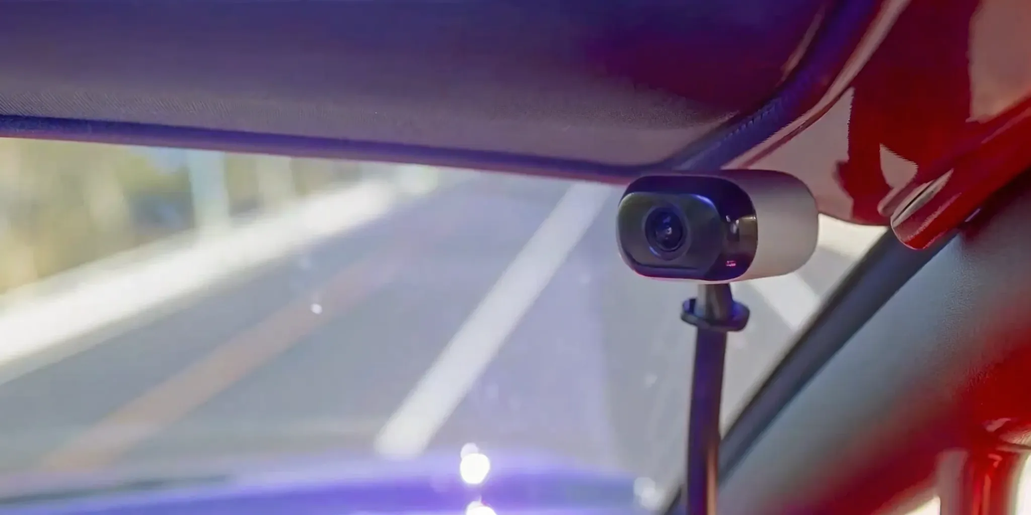 Close-up shot of an advanced ADAS camera sensor mounted on a modern truck windshield, highlighting the complex safety technology requiring certified calibration