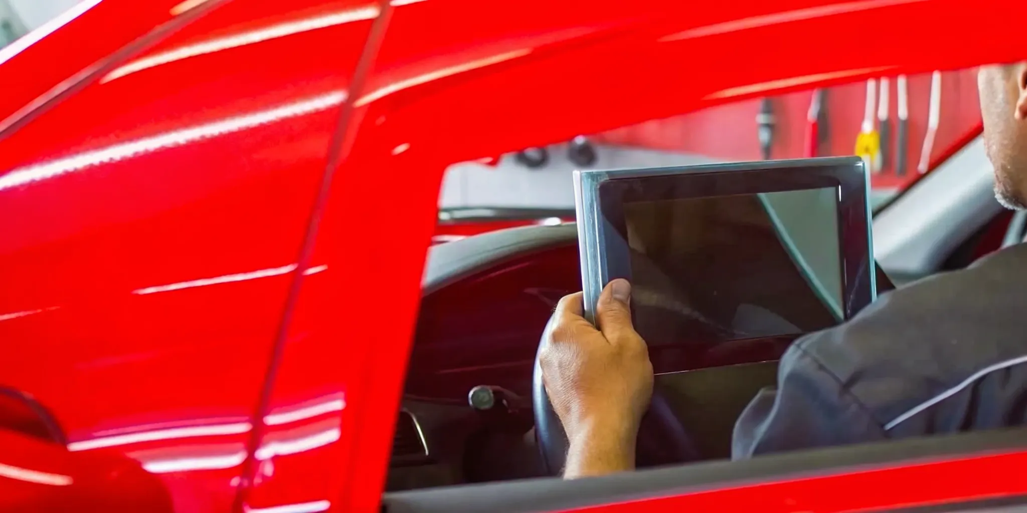 Technician using a calibration target for windshield ADAS calibration