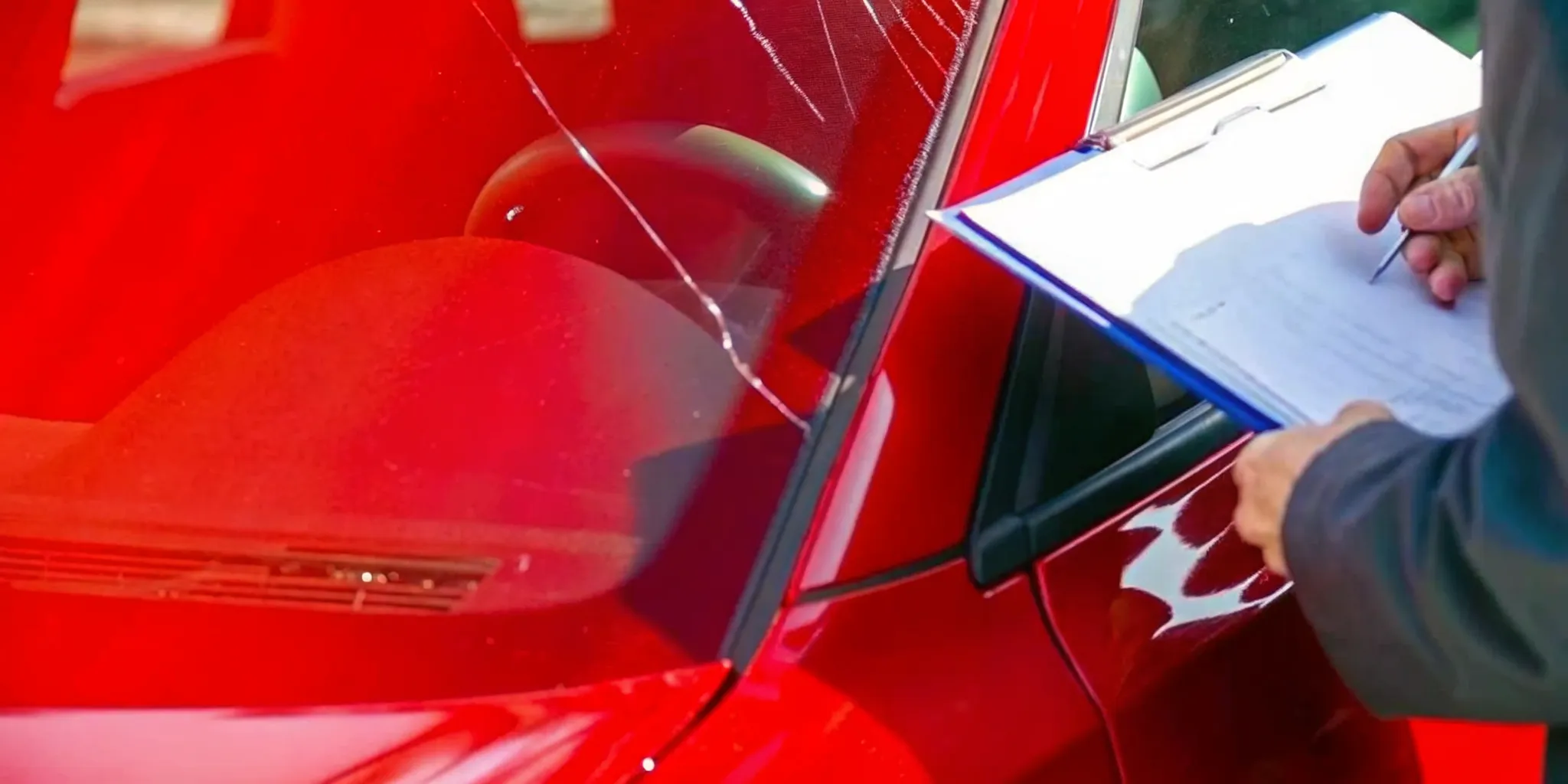 Technician preparing a windshield replacement insurance claim service
