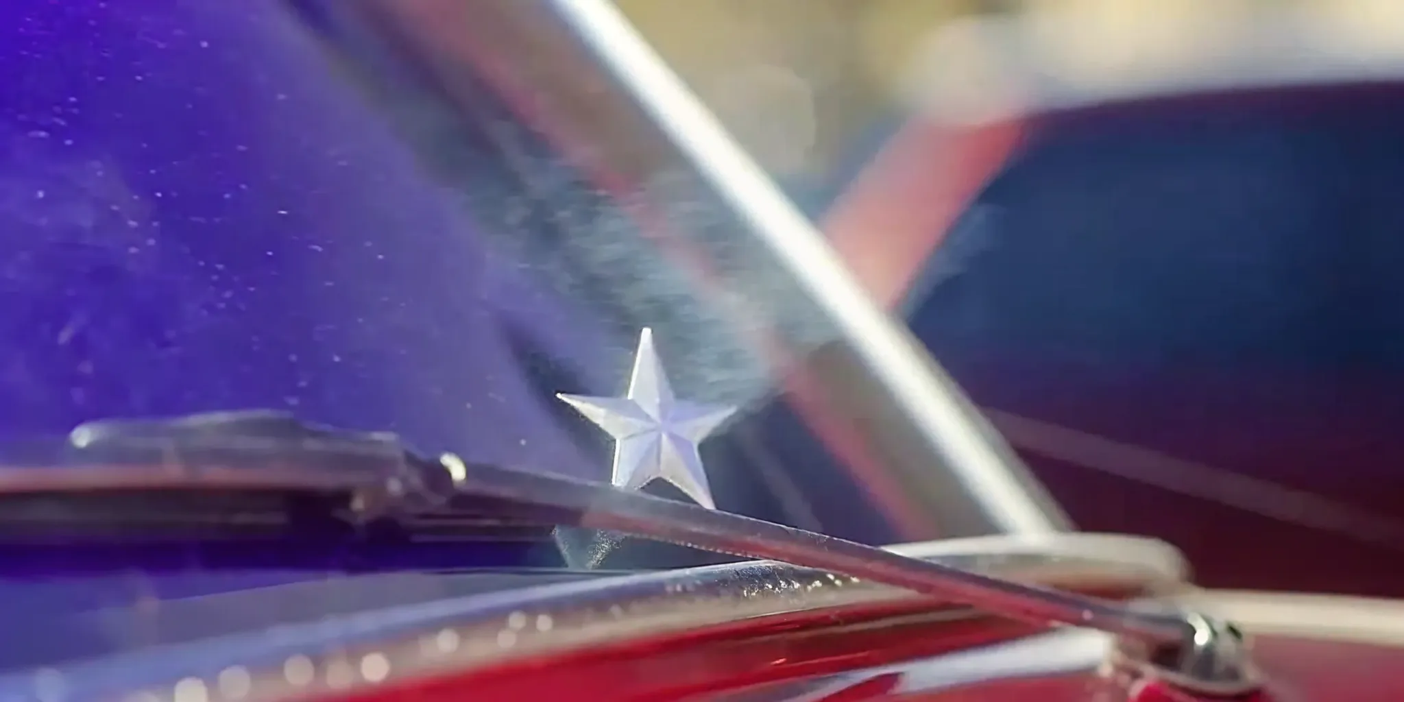 A close up of a small star crack on a windshield being heated under cold winter conditions