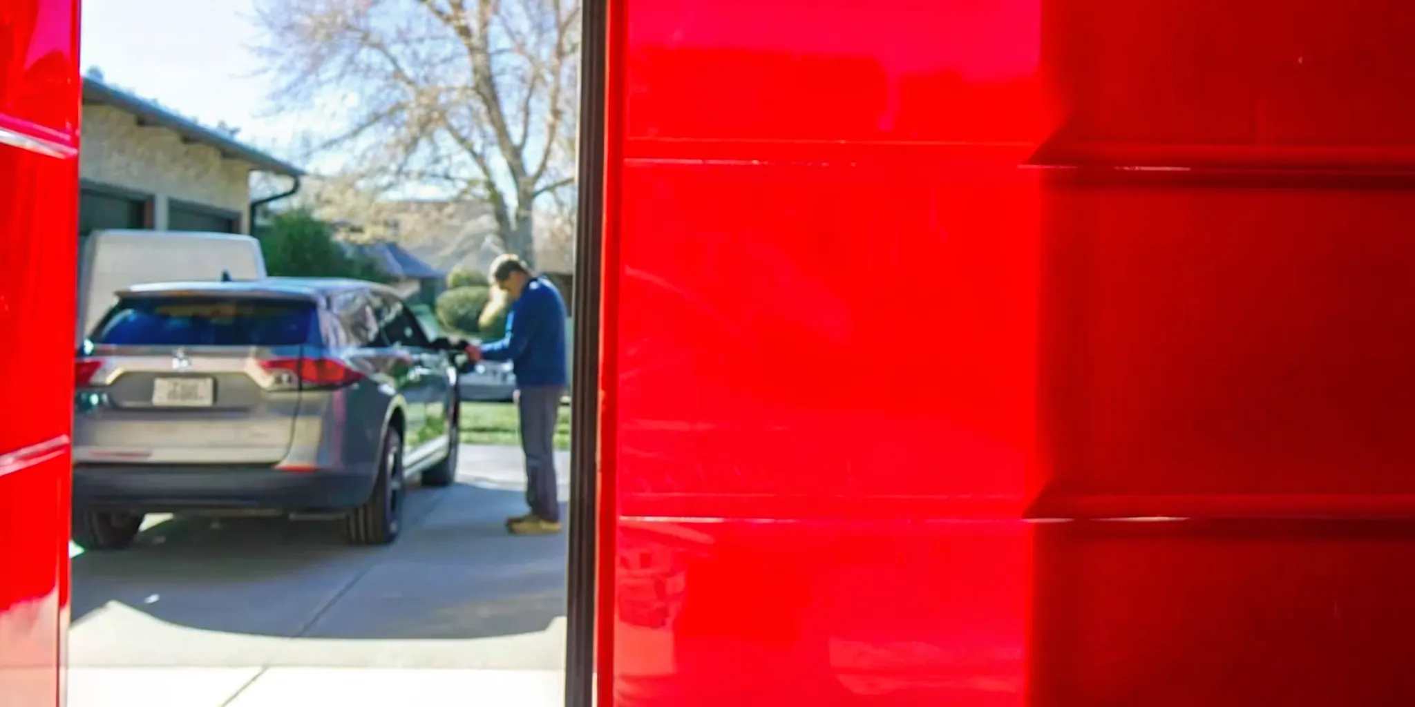 Car parked in driveway with clearance on all sides and mobile auto glass van parked nearby