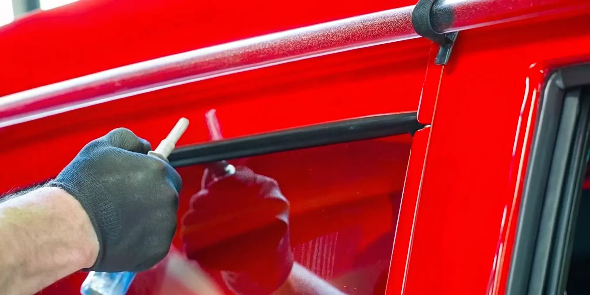 Close-up of a windshield chip repair process with professional tools applied to a commercial truck's glass