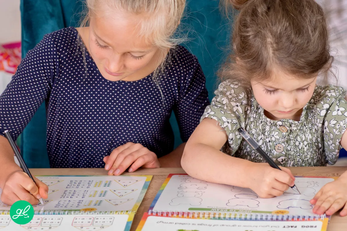 Homeschool student tracing cursive letters in a reusable workbook