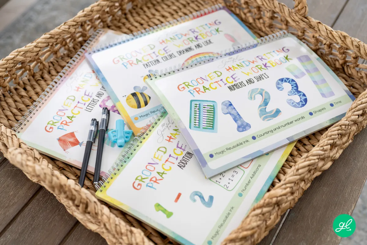 Grooved cursive handwriting workbook with disappearing ink pens