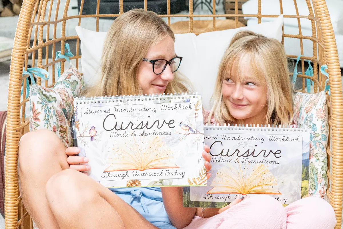 Child practicing connected cursive words with a pencil