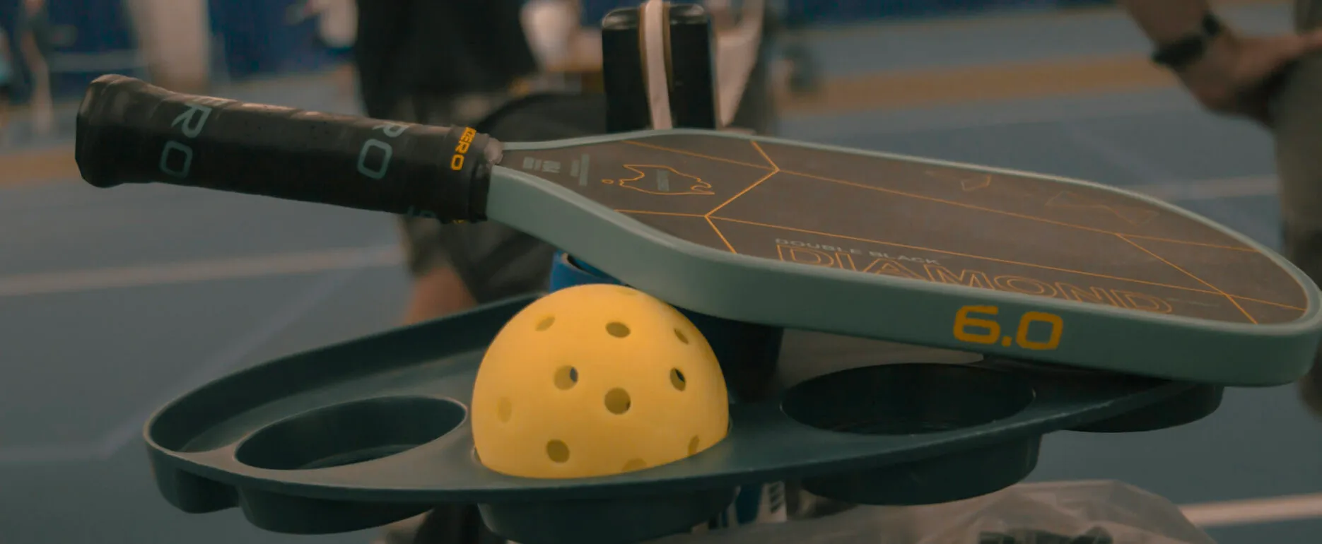 Pickleball paddle and ball at The Wembley Club