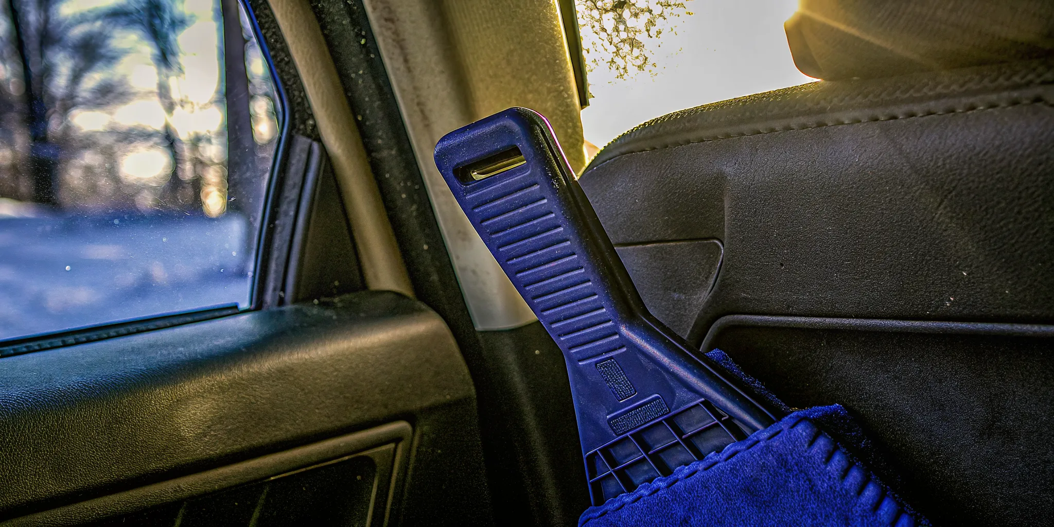 Custom branded premium ice scraper with logo stored inside a car door pocket
