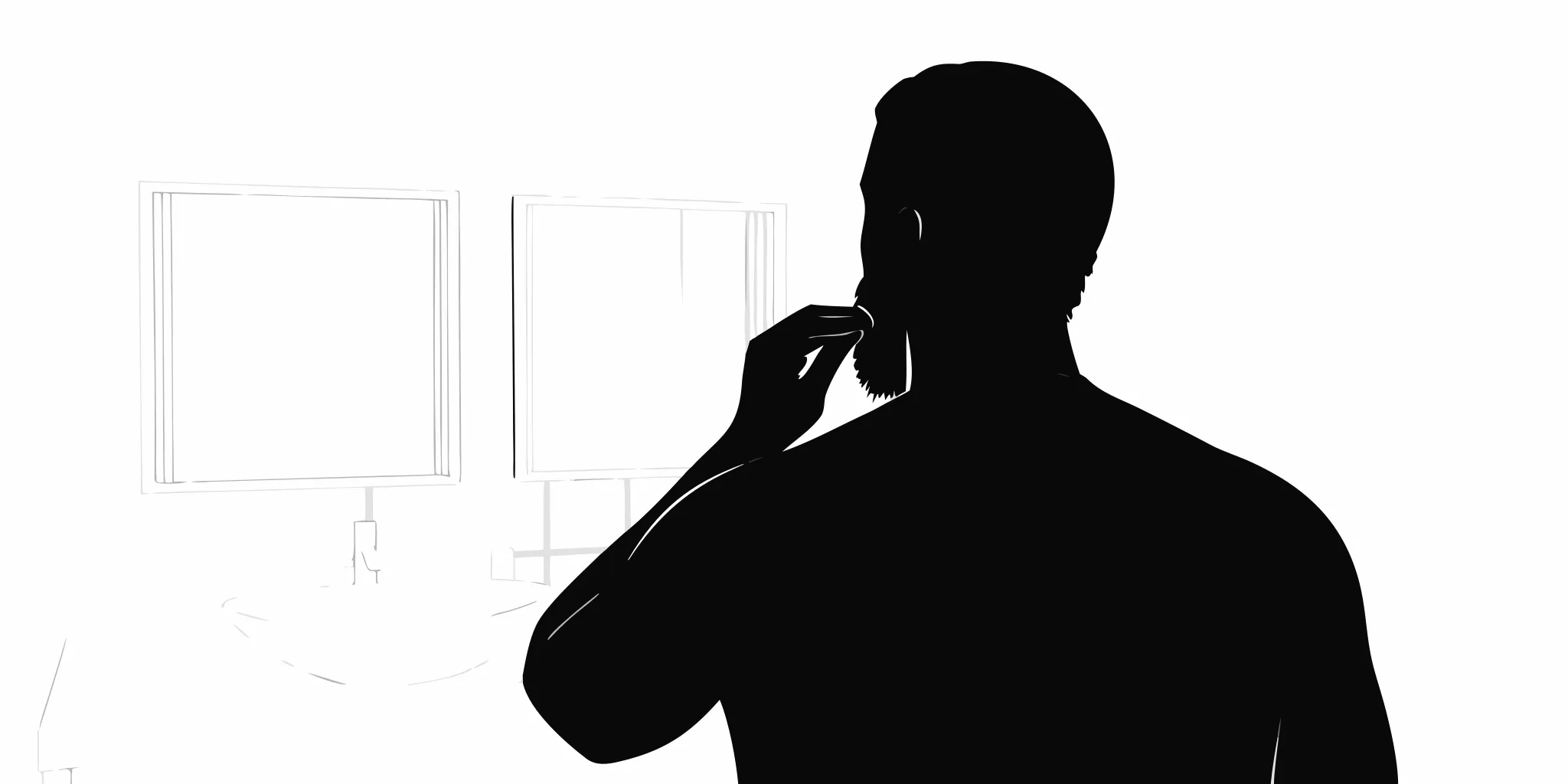 Man brushing his beard in a bathroom mirror during his morning grooming routine