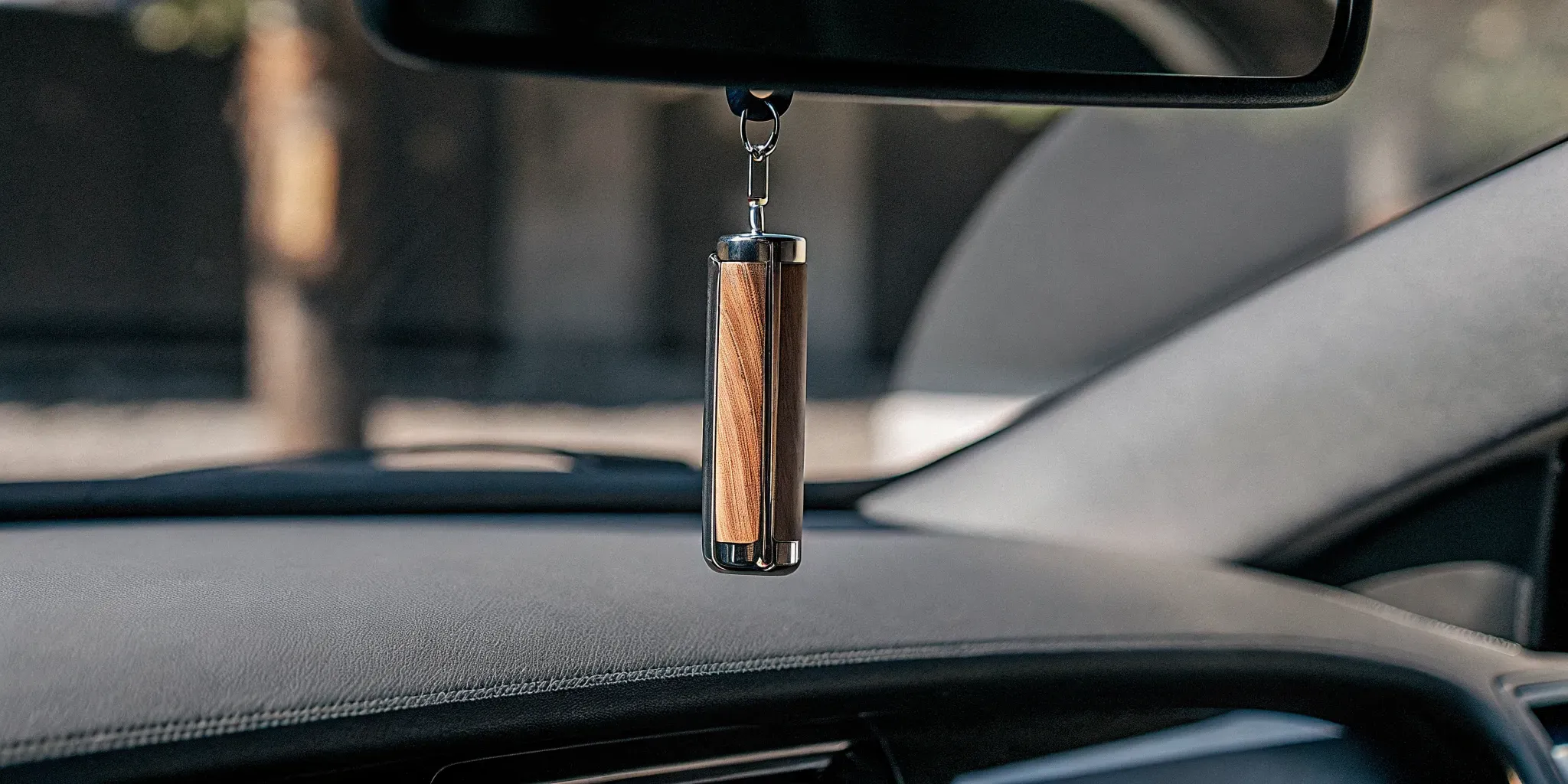 Wood and metal car freshener in a clean modern car interior