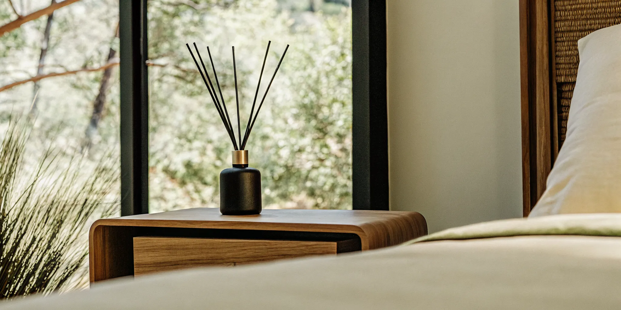 Luxury home fragrance diffuser in a calm modern bedroom