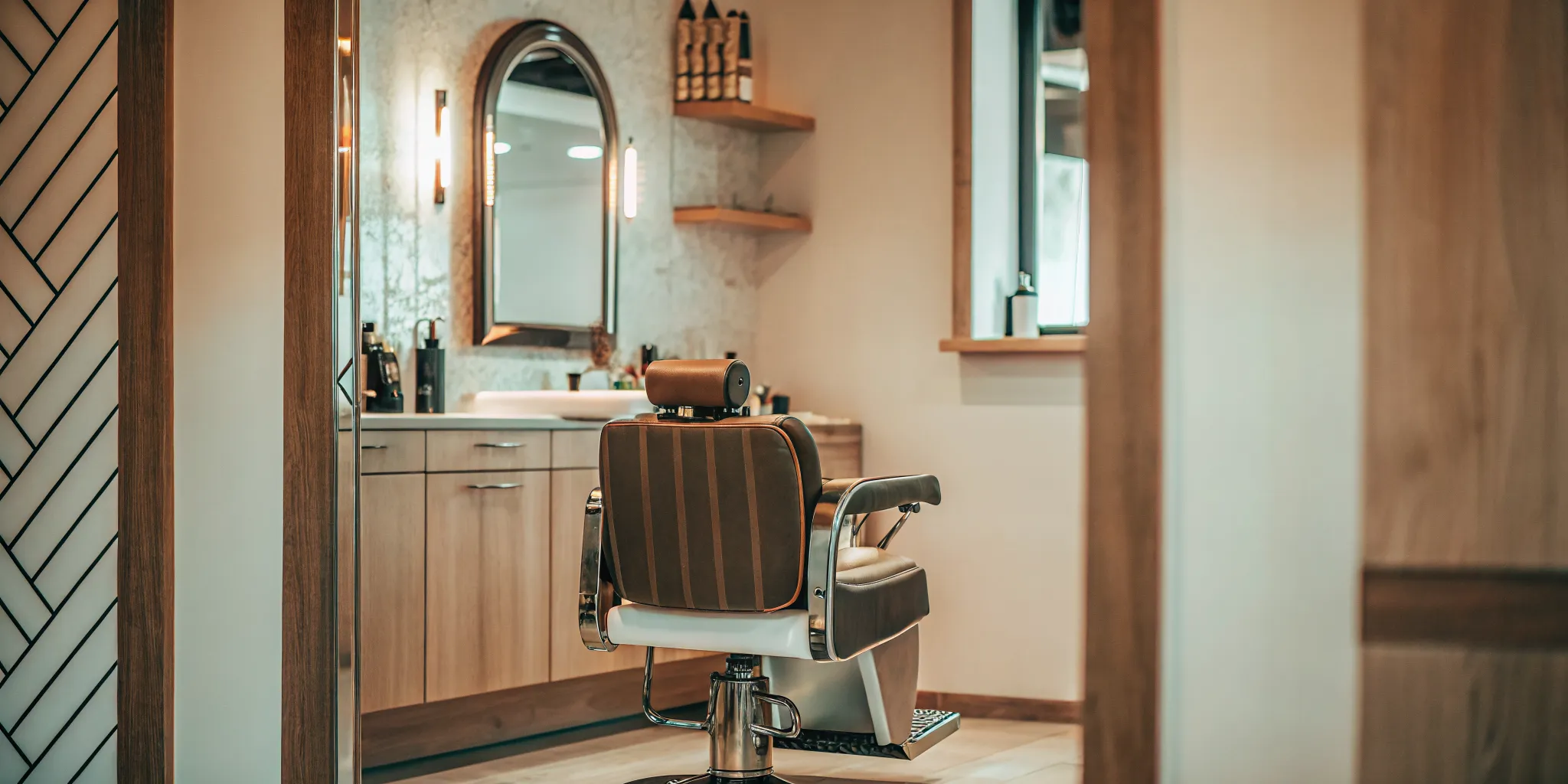 Modern private barber suite with styling chair, mirror station, and warm decor in a salon suite rental facility