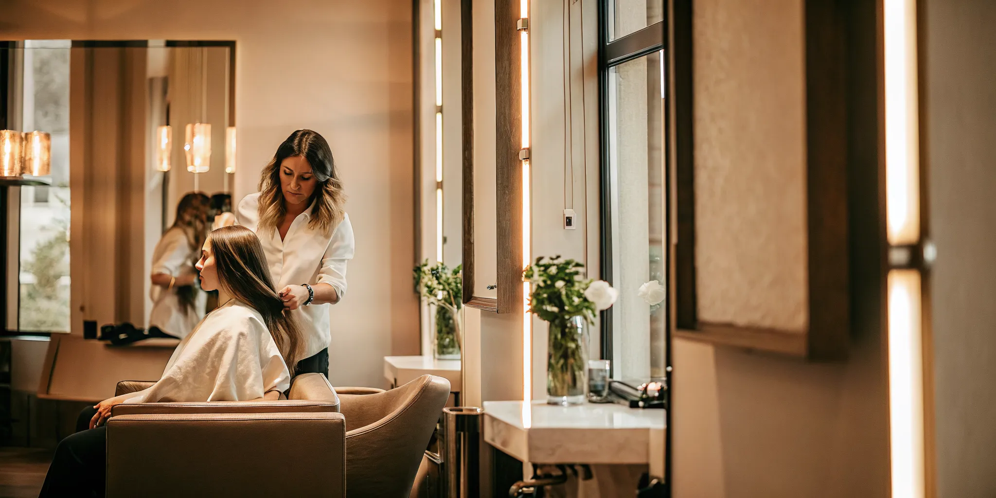 Experienced beauty professional consulting with a client in a private salon suite