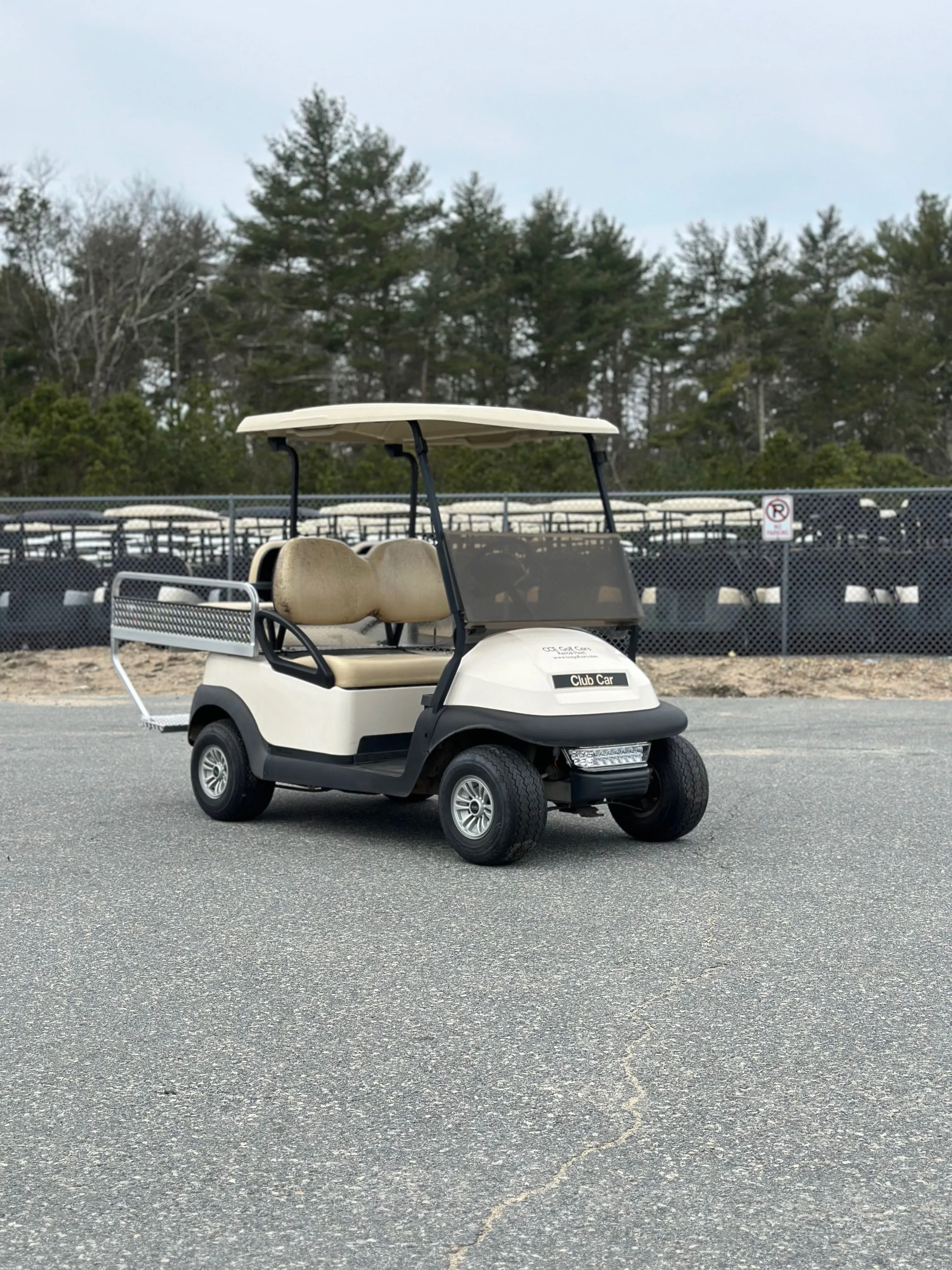 Four-passenger golf cart with rear storage box for rental operations