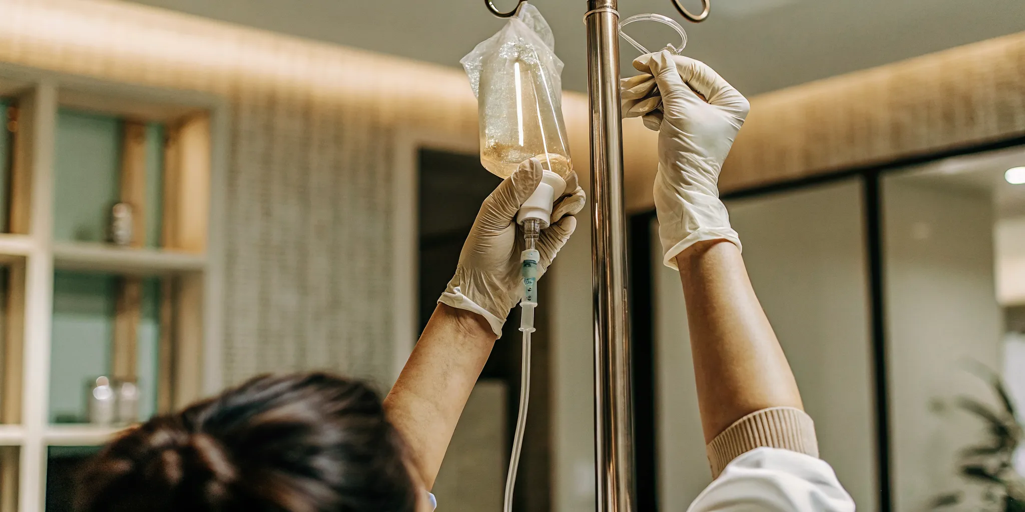 Medical professional preparing an IV drip bag at a wellness clinic