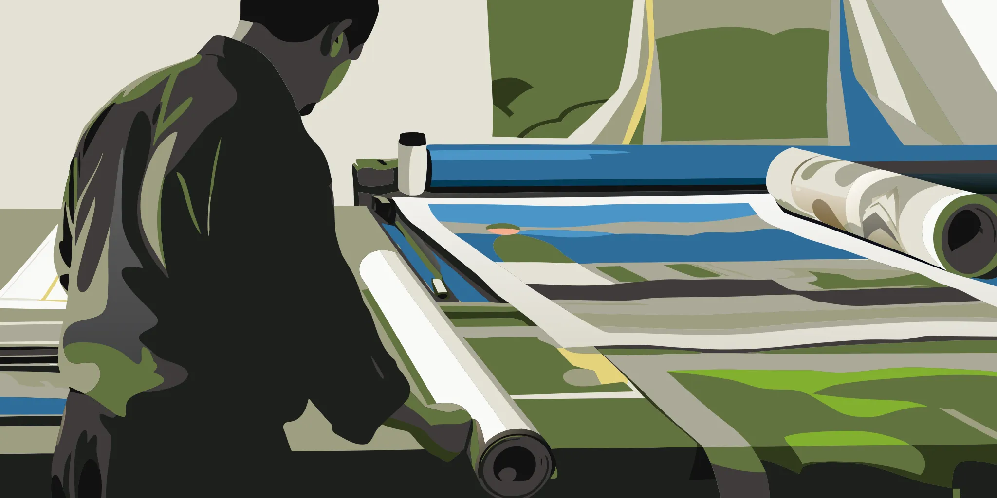 Designer reviewing large-format vehicle wrap proofs in a print production studio