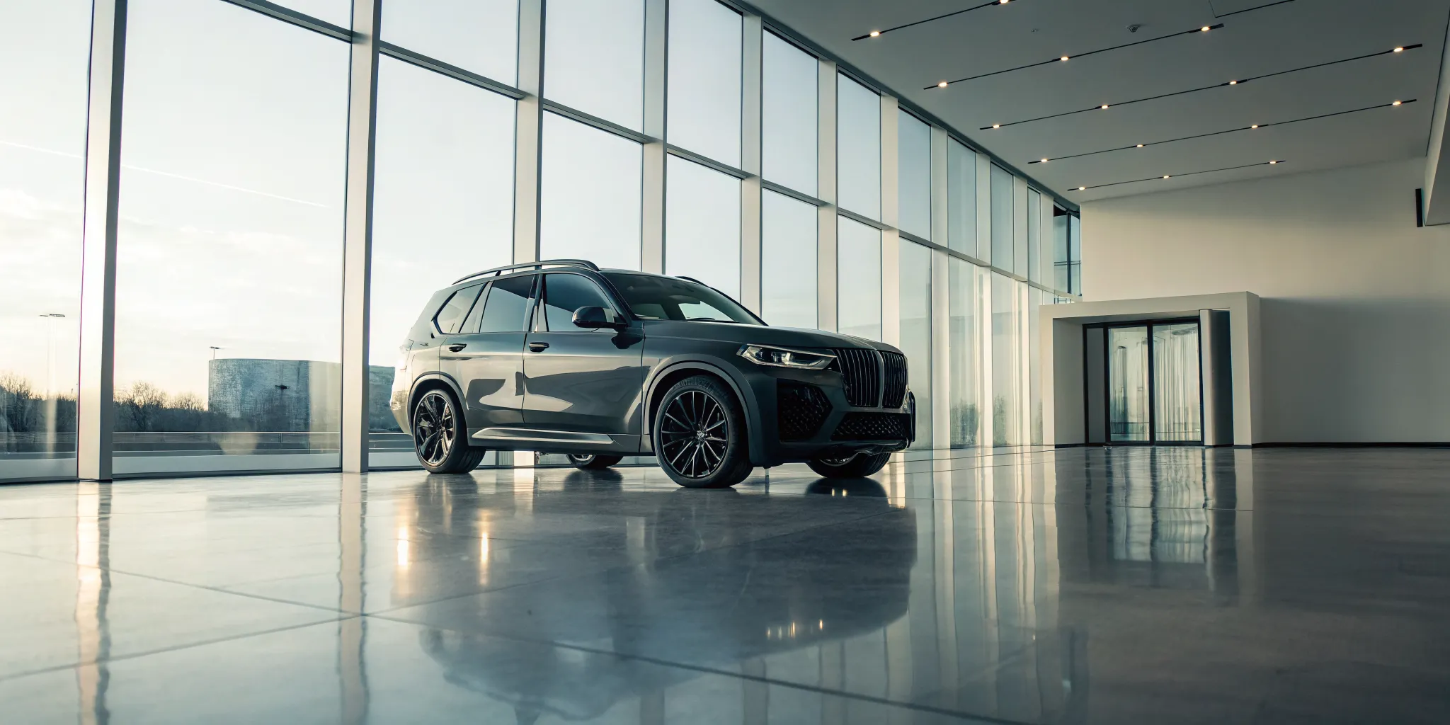 A BMW X7 M performance SUV for sale on a dealership showroom floor.