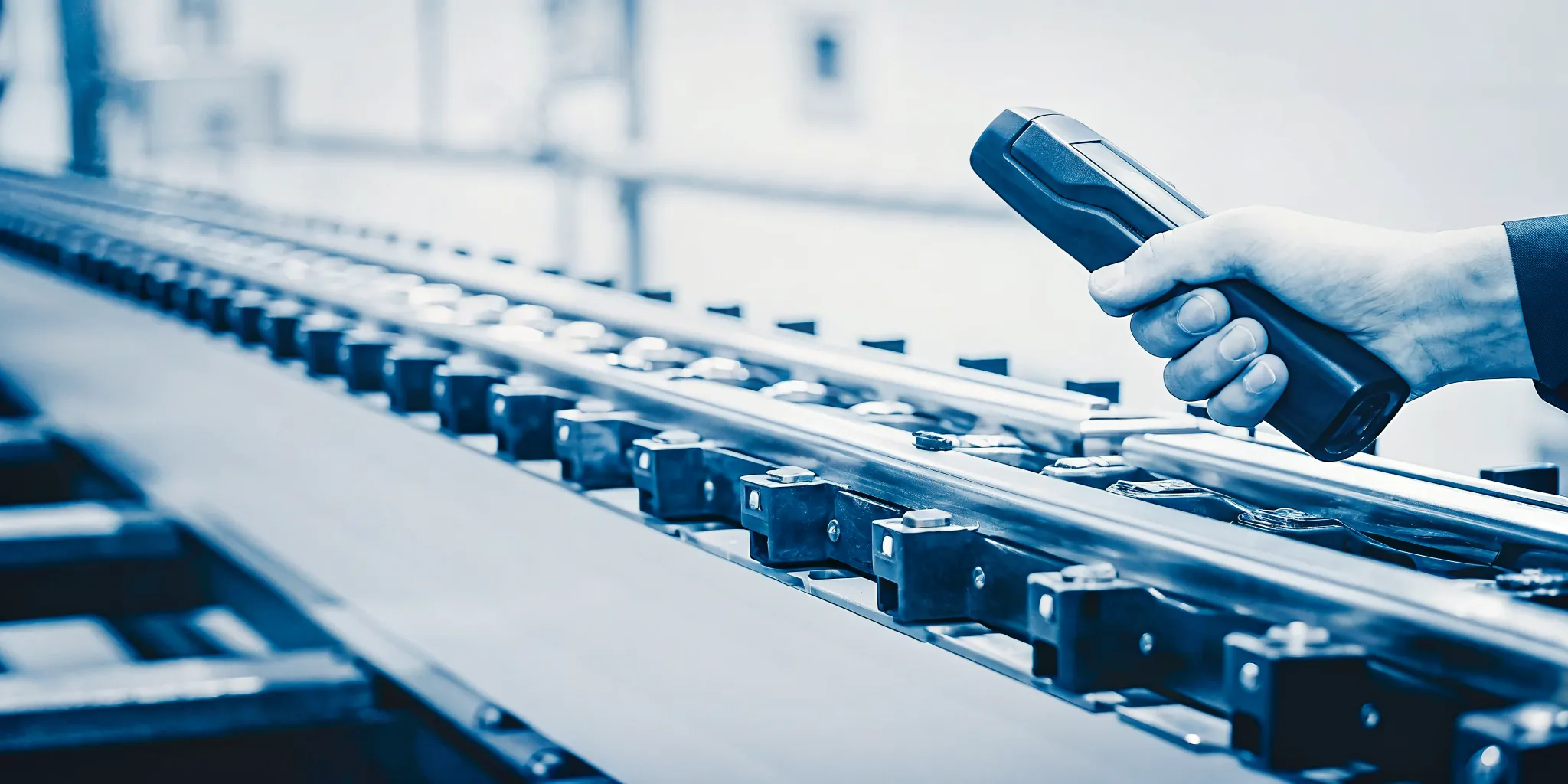 Engineer scanning a serialized machined component to update its genealogy record in manufacturing traceability software