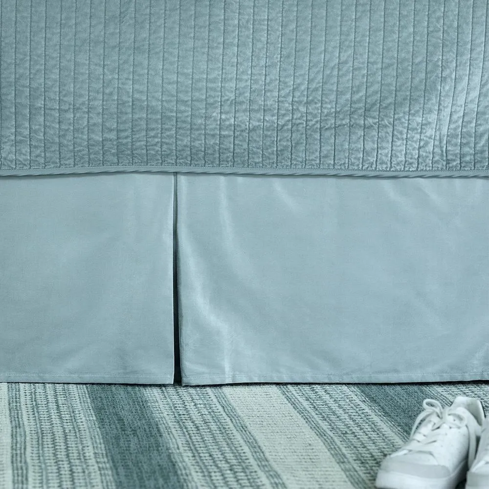 Tailored velvet bed skirt styled in a luxury bedroom