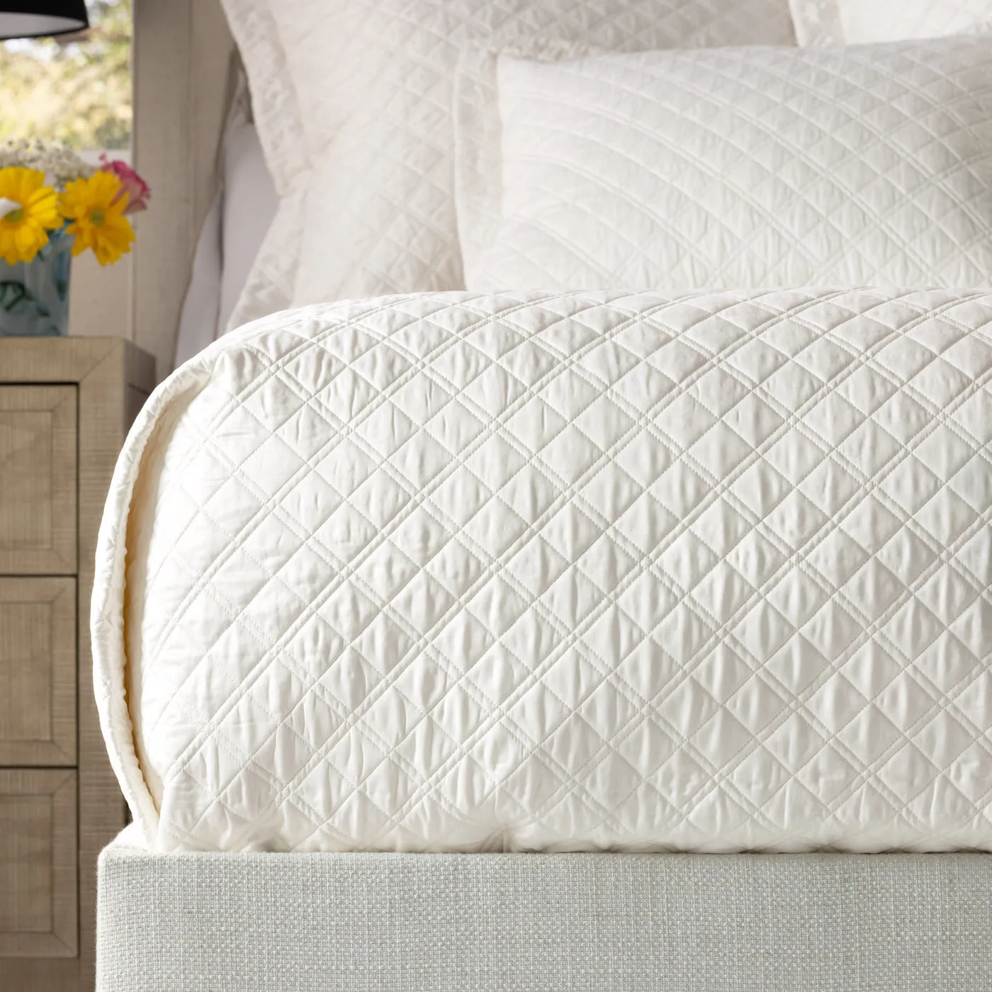 Ivory silk diamond quilted coverlet for a polished luxury bed