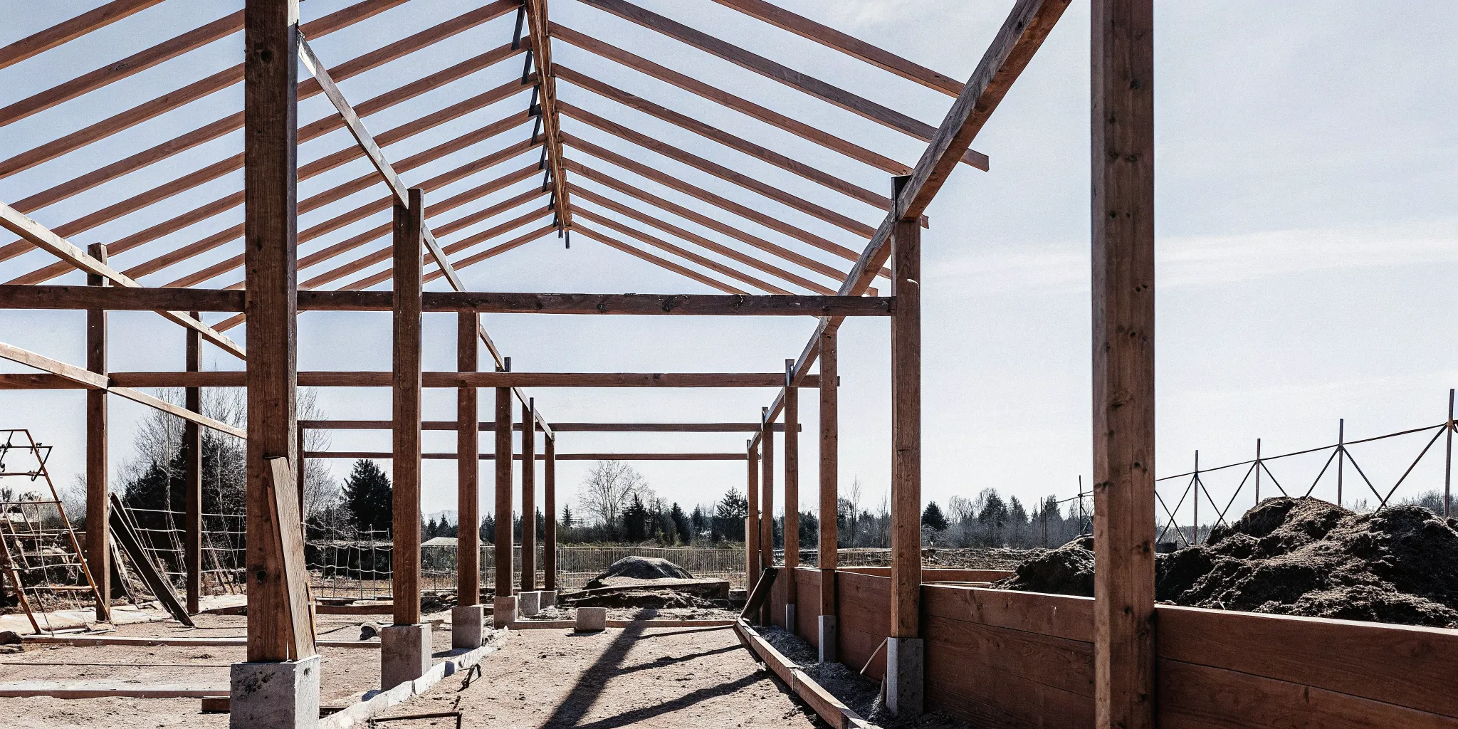 A pole building under construction in Washington state showing strong post-frame wooden posts and roof trusses.