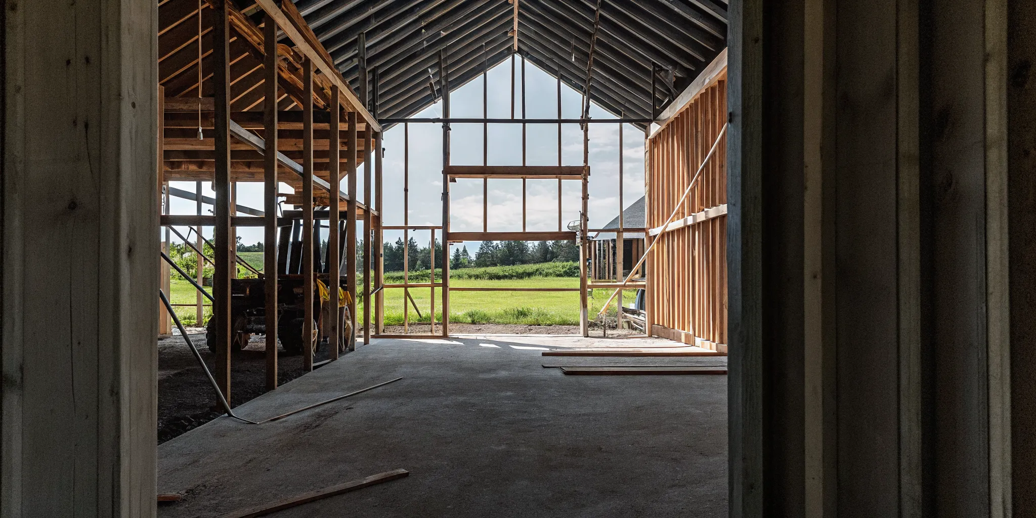 Post-frame construction structure showing posts and roof trusses