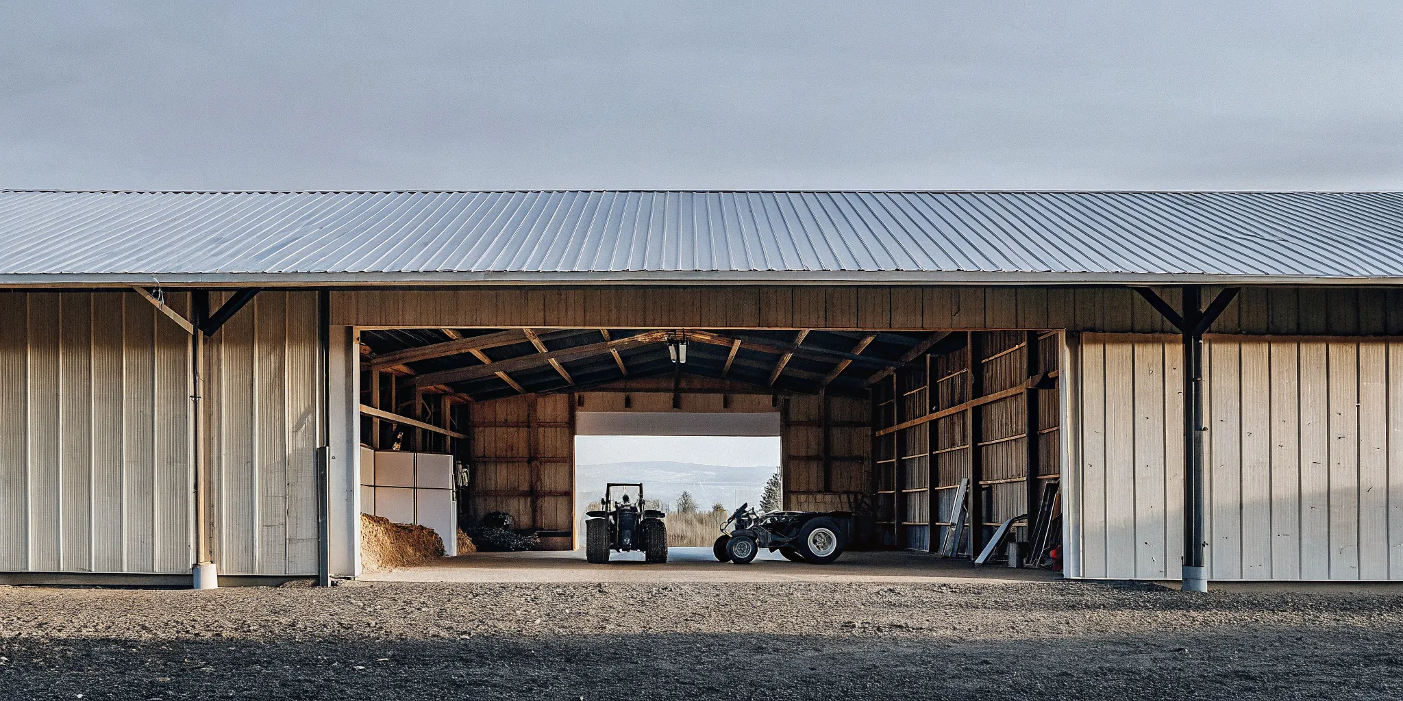 Agricultural pole building with an open equipment bay in the Pacific Northwest