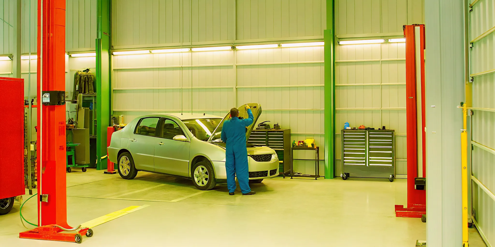 Collision repair technician reviewing body work before final vehicle pickup in Orlando
