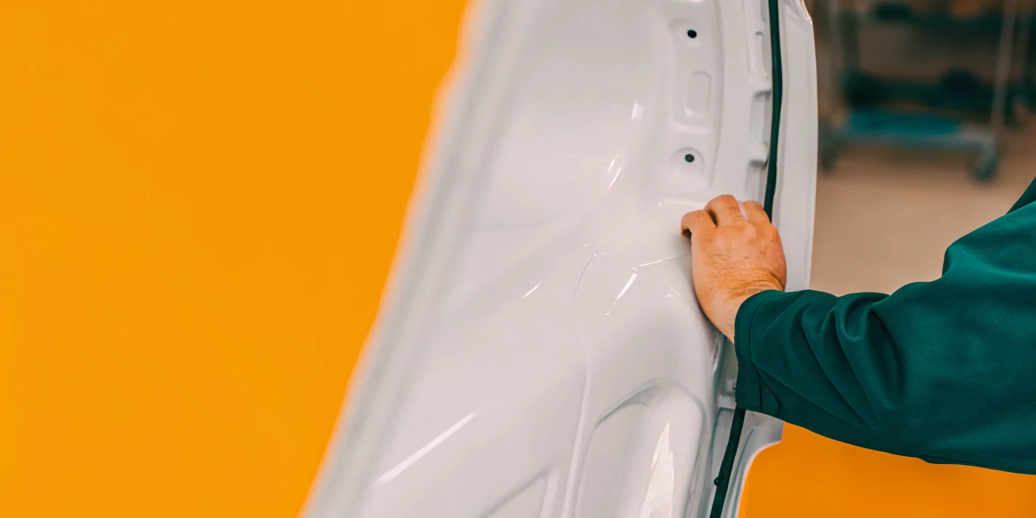 Technician inspecting a vehicle panel during fender repair in Orlando