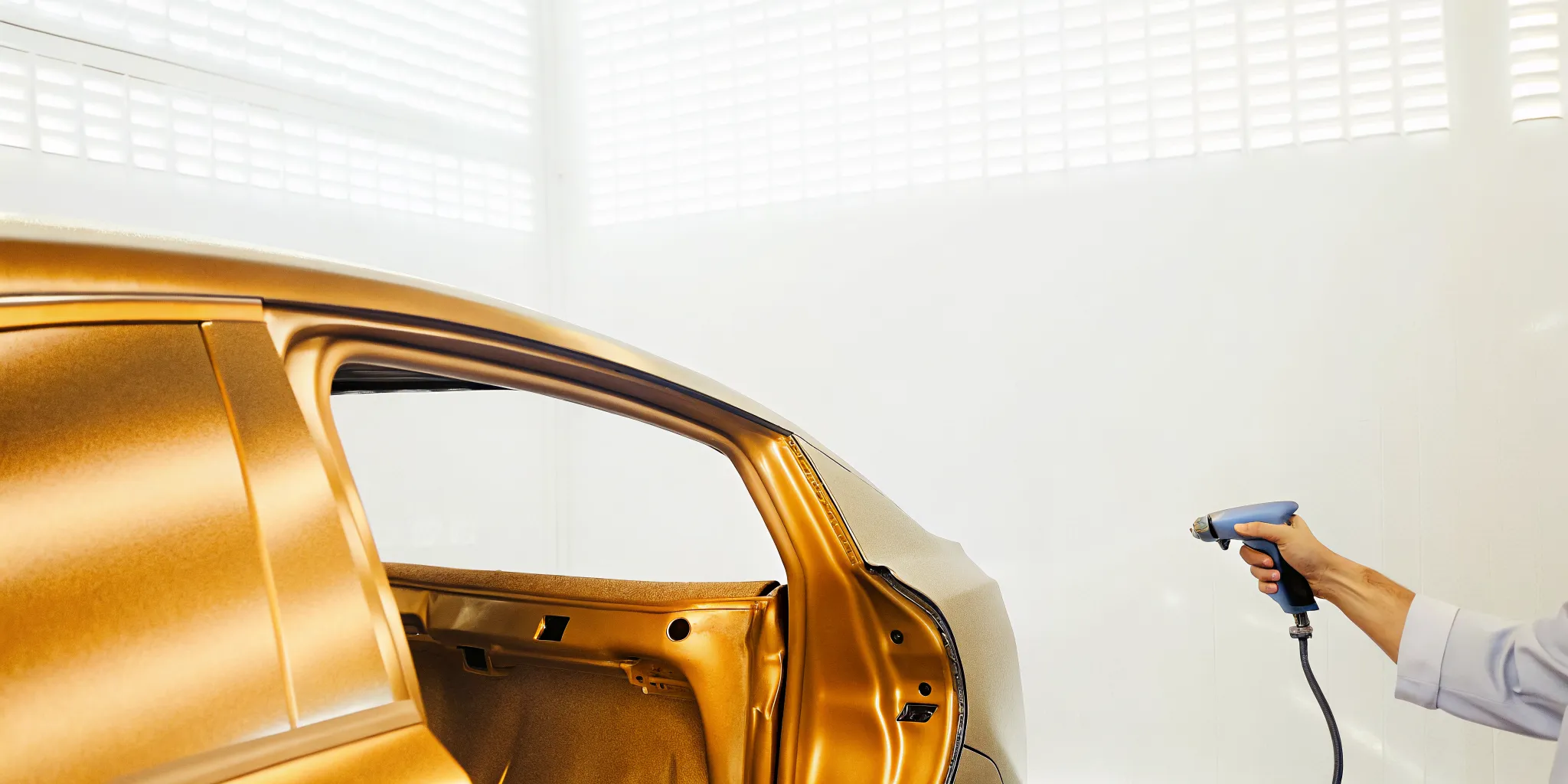 Technician using a color scanner for auto paint matching Orlando repairs