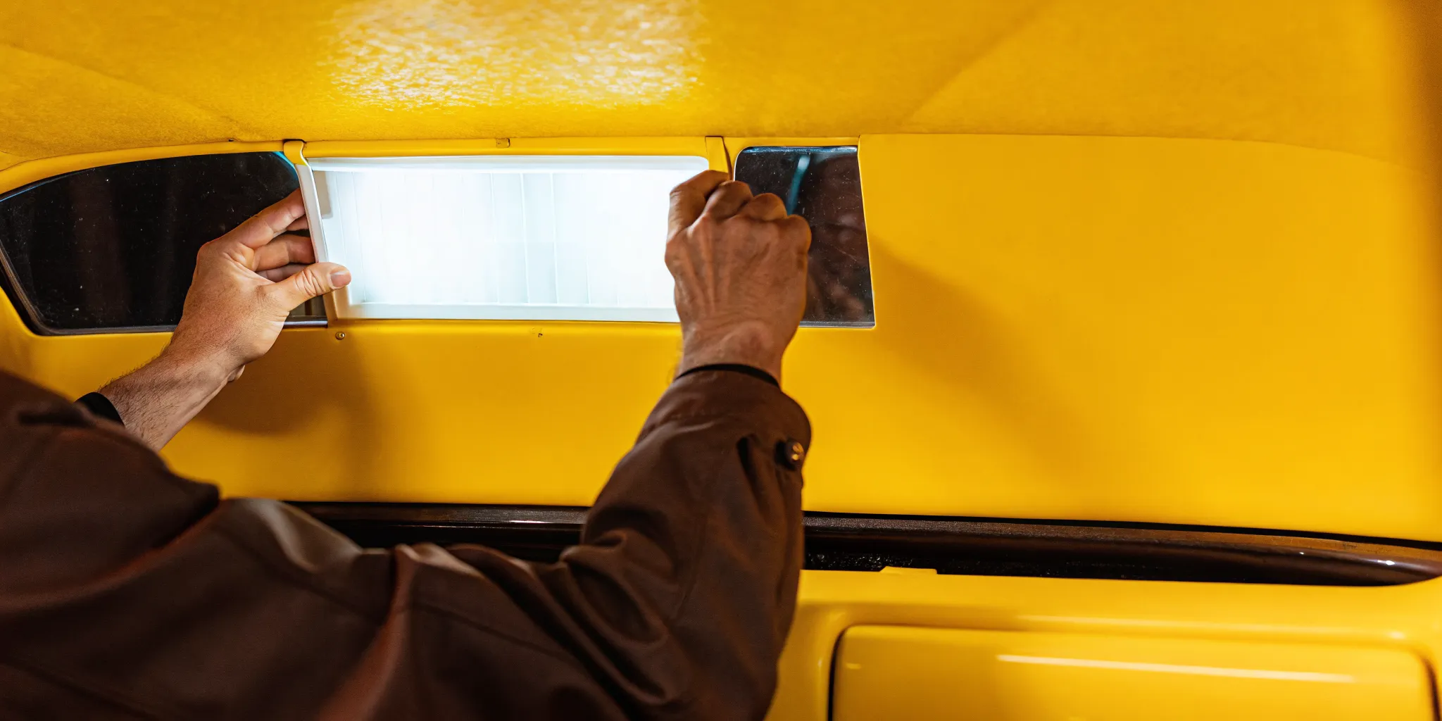 Technician inspecting a vehicle interior for hidden water damage after an Orlando storm