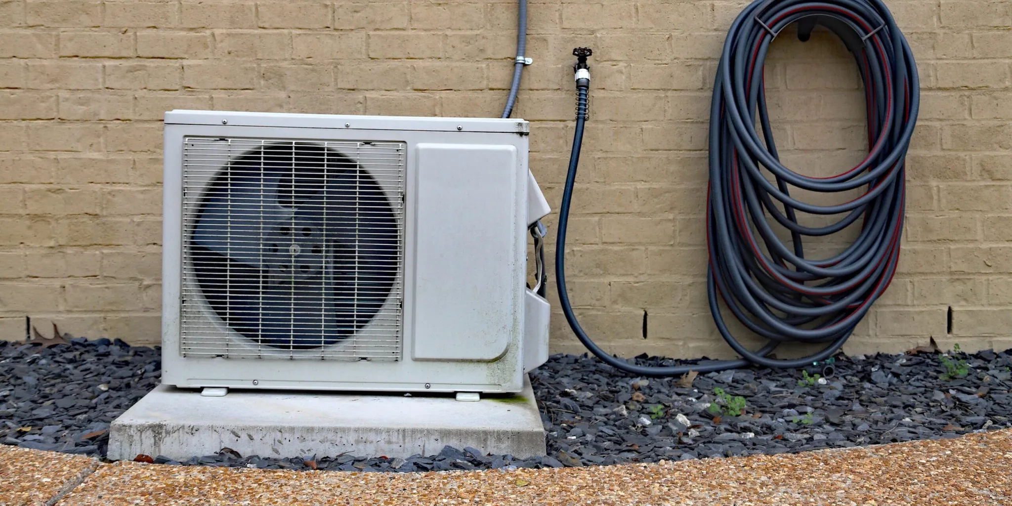 Ductless mini-split outdoor condenser connected to a Kernersville home