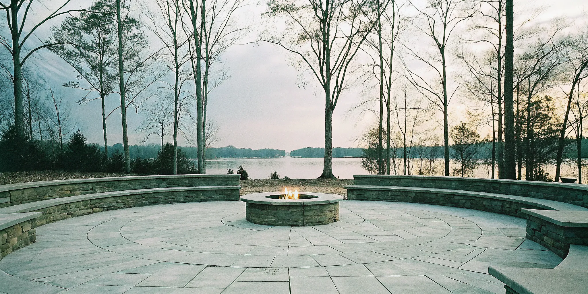 Round stone fire pit with social seating by Lake Norman