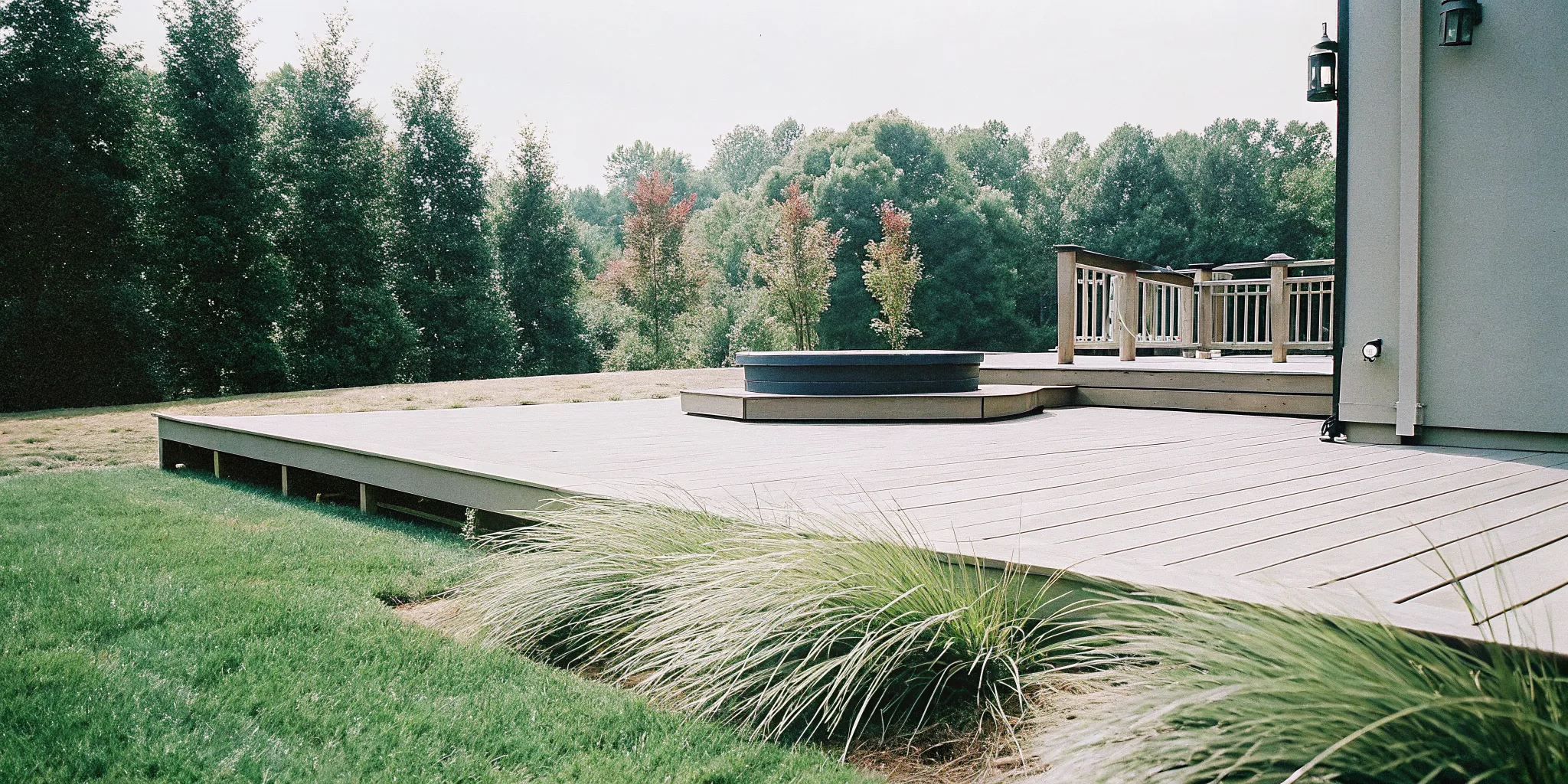Sleek, slip-resistant composite decking surrounding a luxury hot tub in a backyard retreat