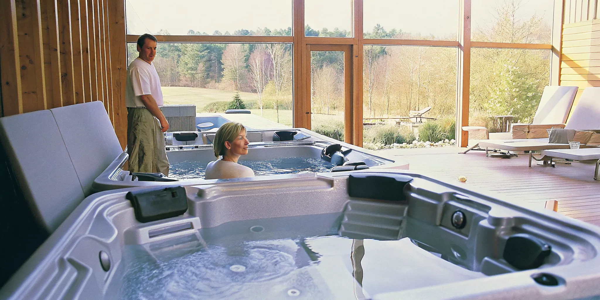 Couple evaluating comfort during a private hot tub test soak in a showroom