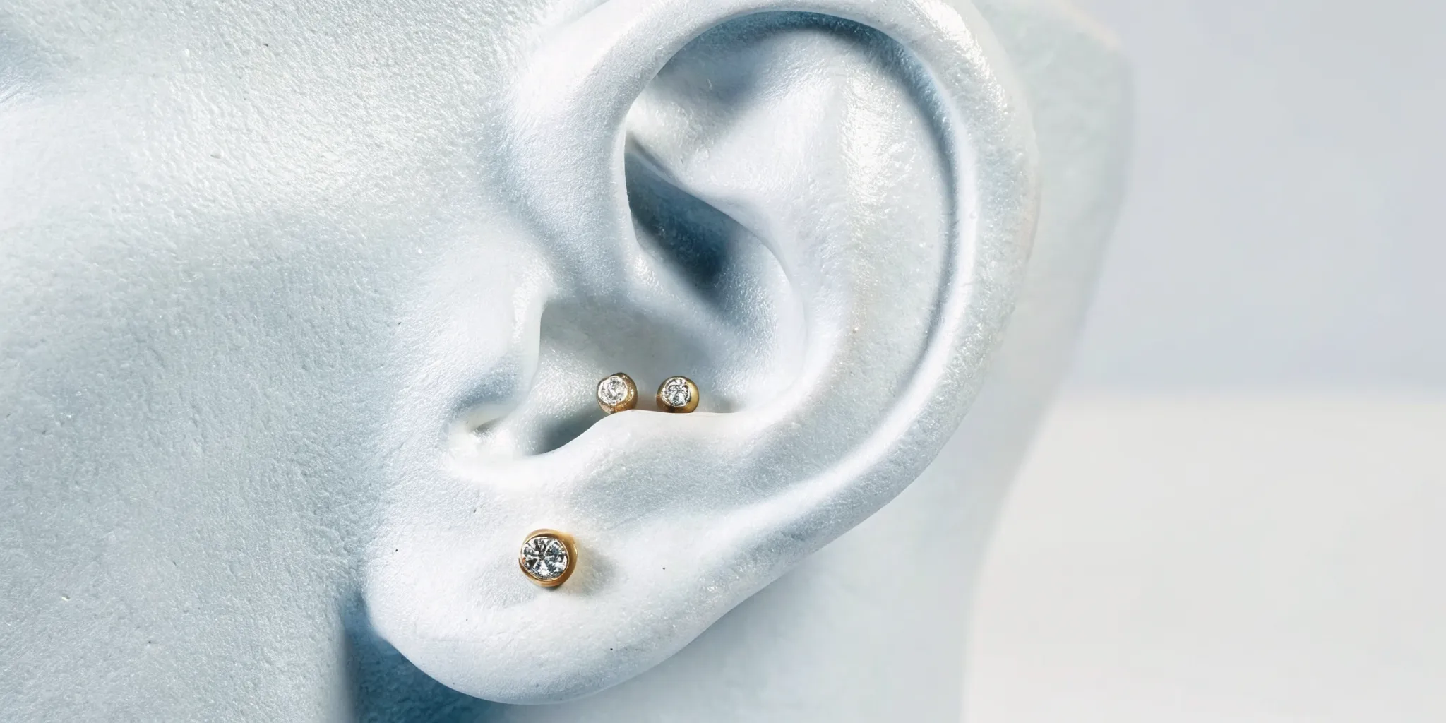 Curated ear showing lobe, helix, conch, and tragus piercing placements