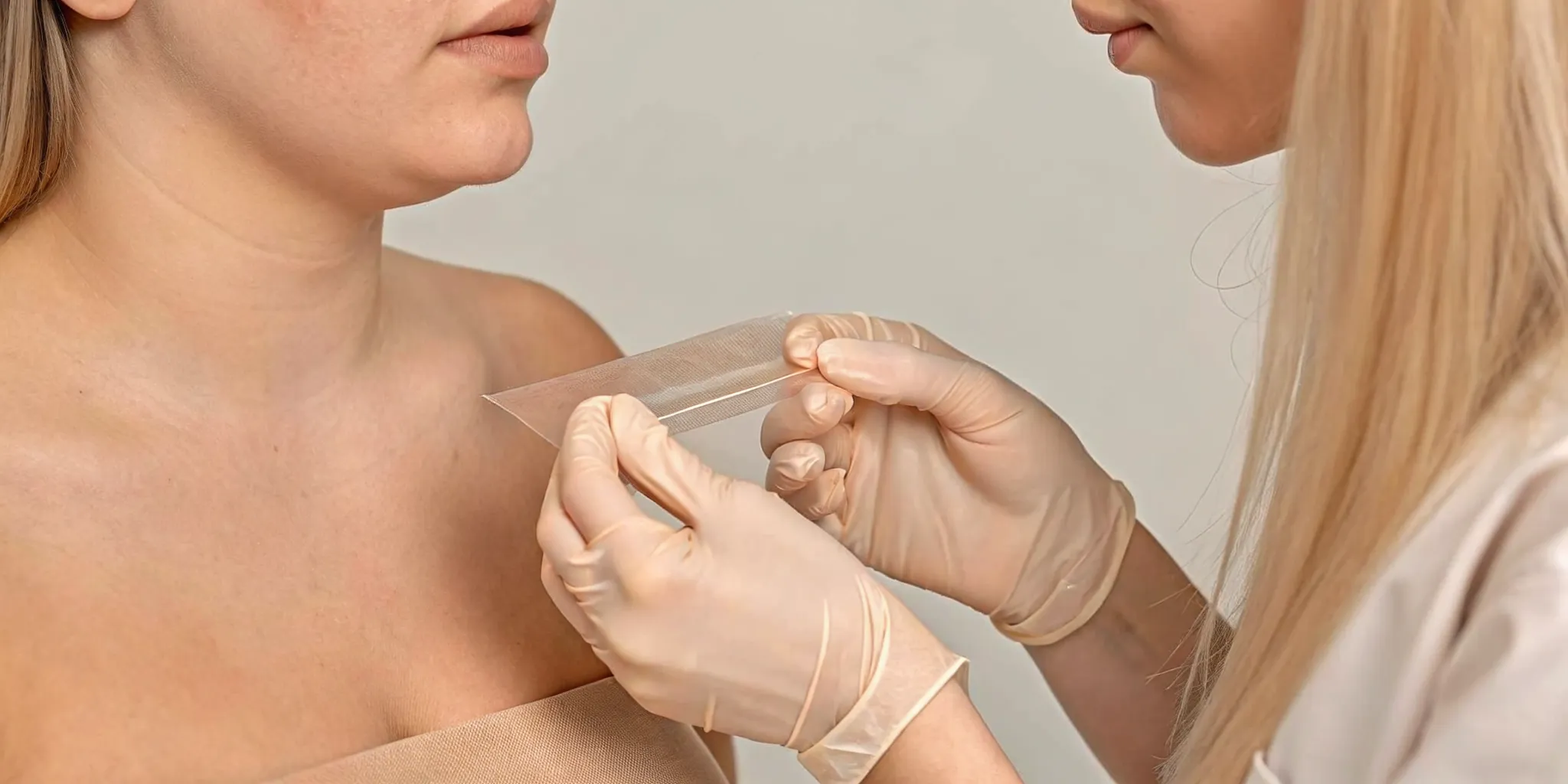 Professional piercer reviewing sterile supplies and titanium jewelry in a clean studio