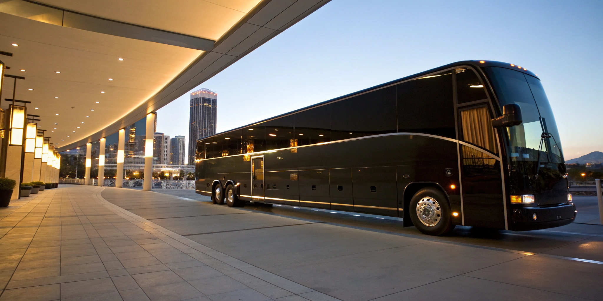 A modern charter bus parked at a terminal, a key factor in calculating rental prices.