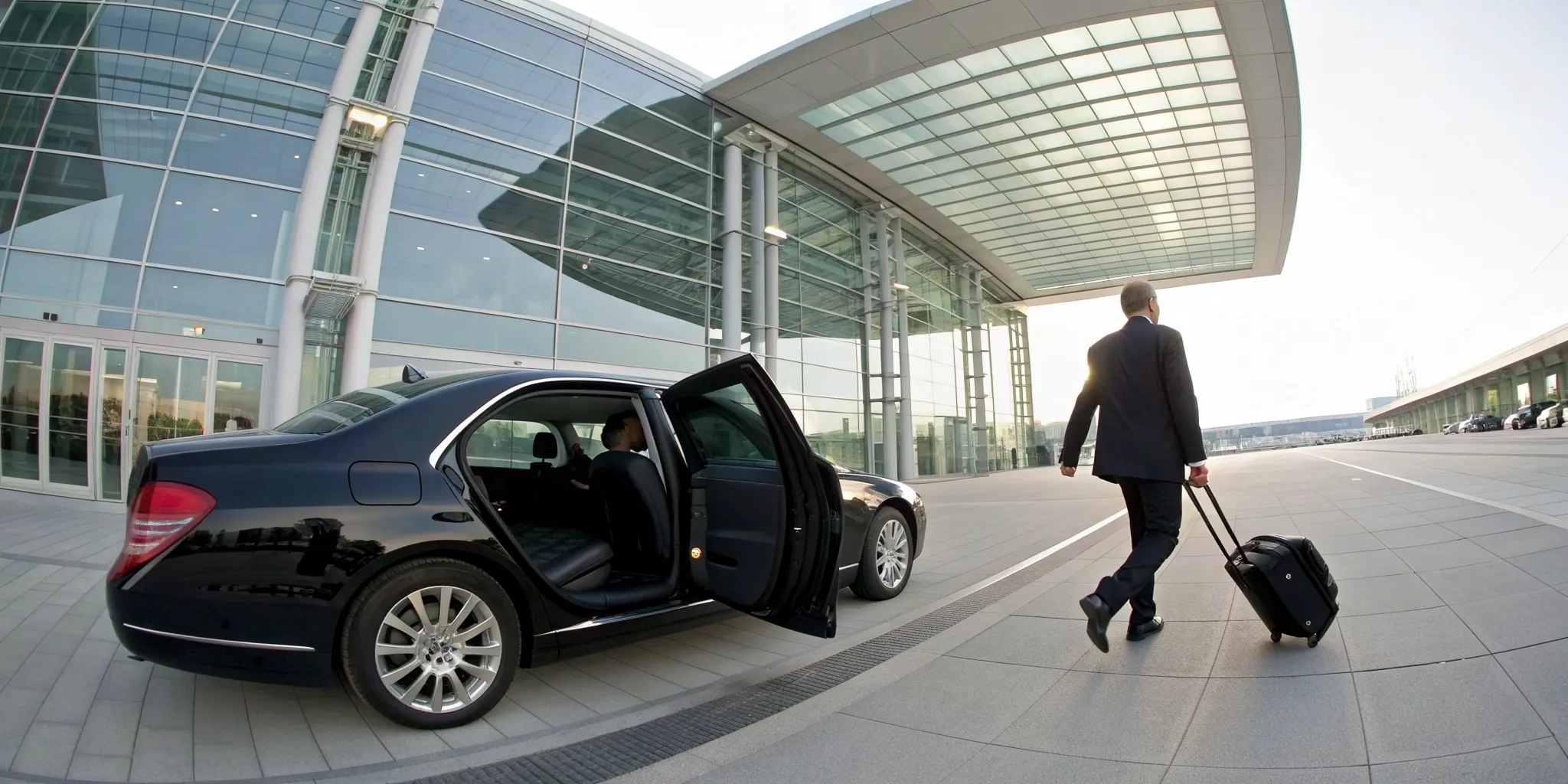 A traveler arriving via a Wayne airport limo service at the terminal.
