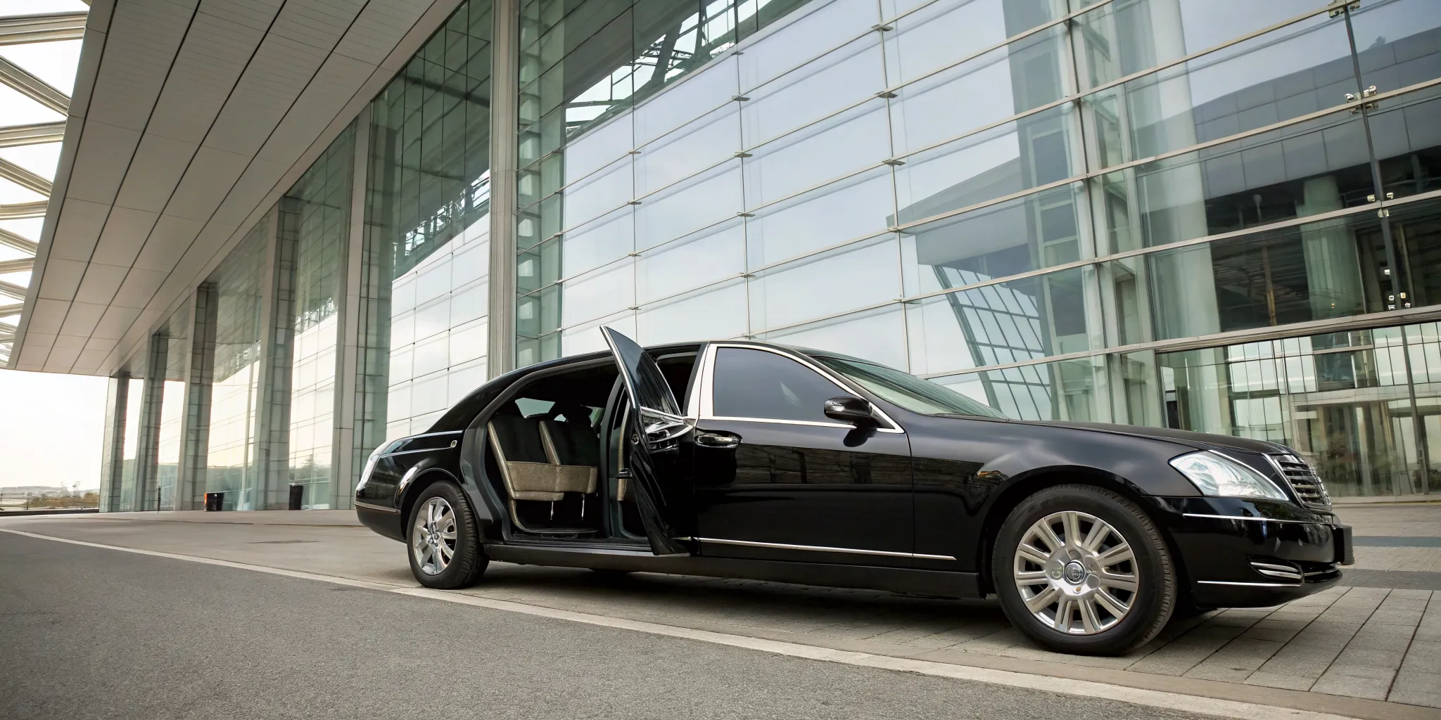Black luxury airport limo for Glen Mills service with an open door.
