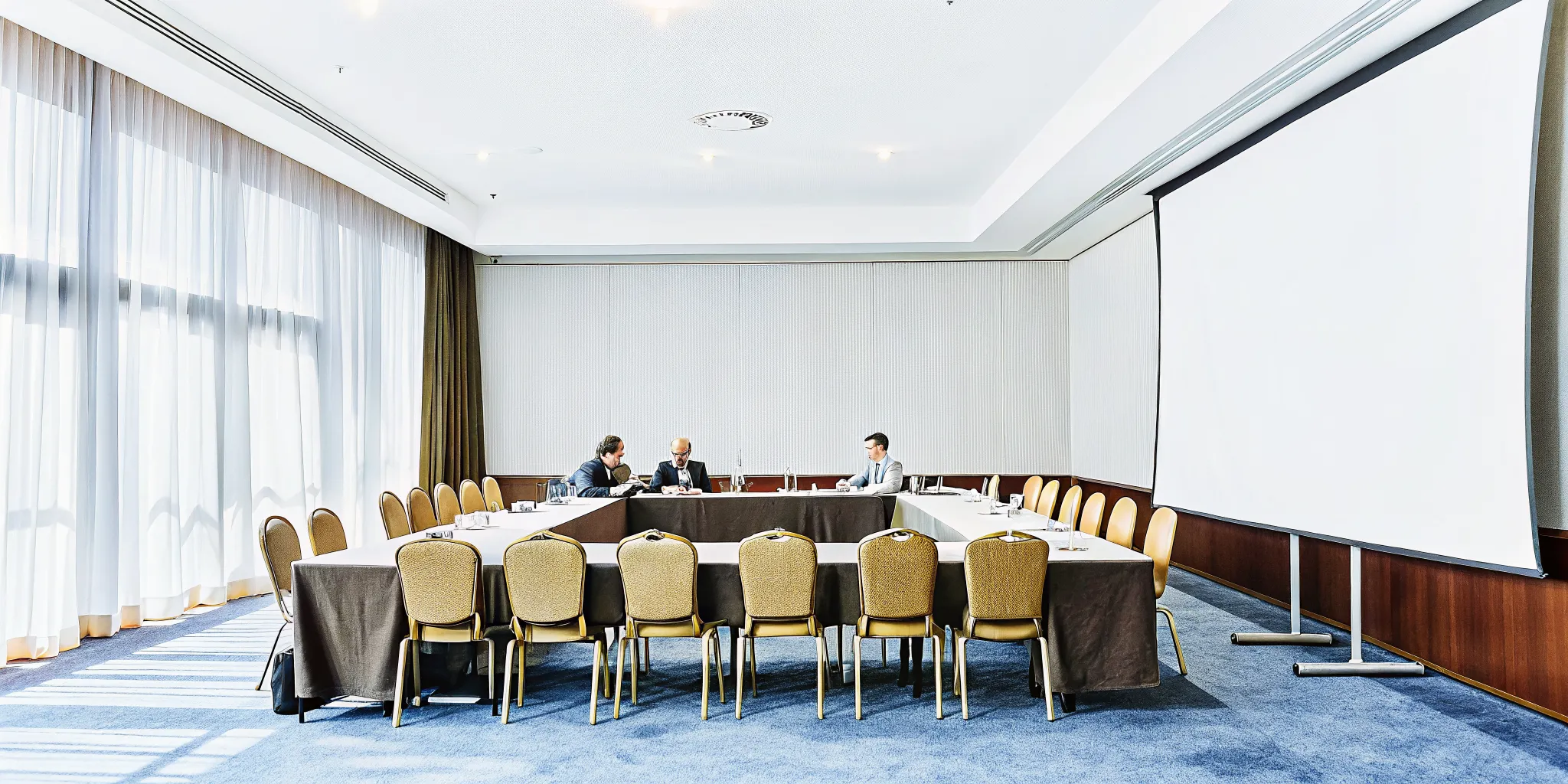 Standard hotel conference room with business meeting setup