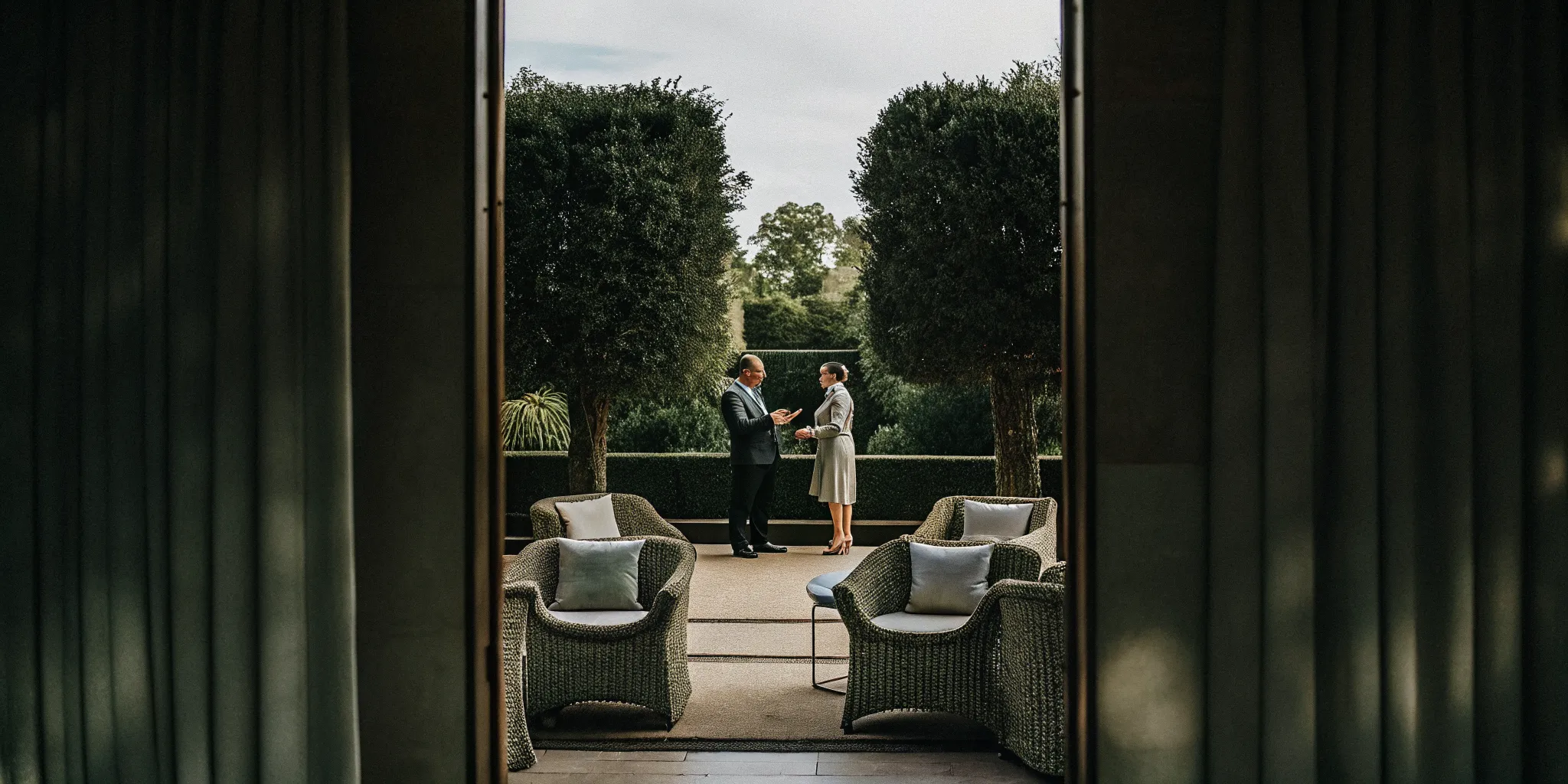 Executives in conversation on a private estate terrace near Boston