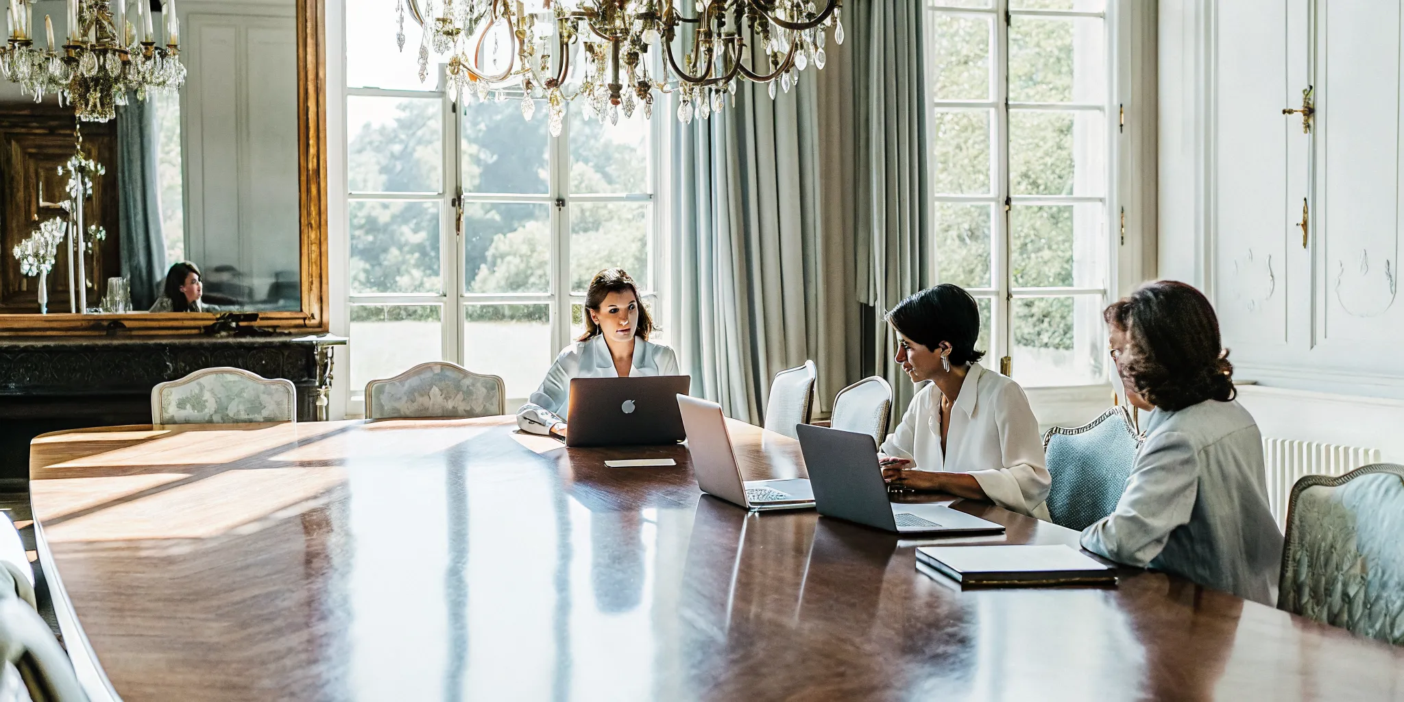 Executive leadership team gathered around a conference table inside a French chateau-style private estate for a corporate retreat strategy session