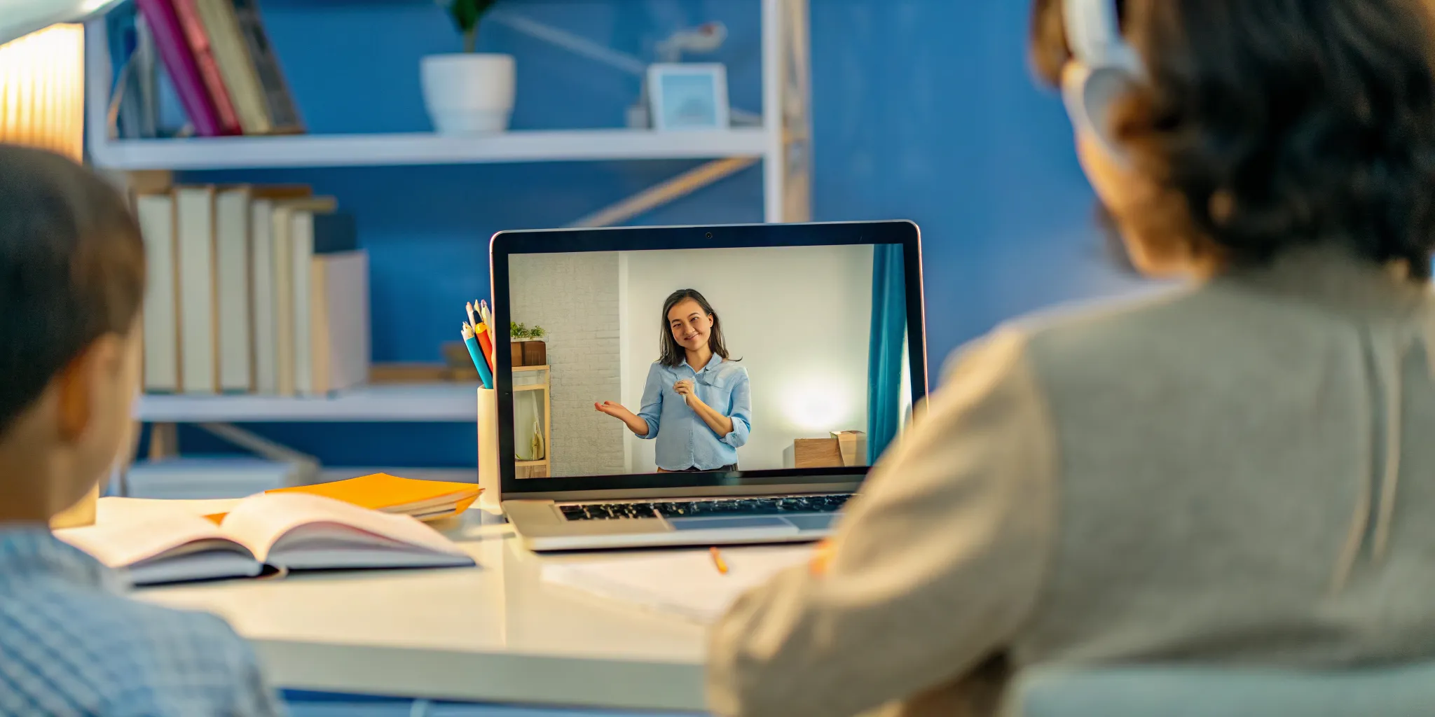 Student attending a live online class with an instructor visible on screen