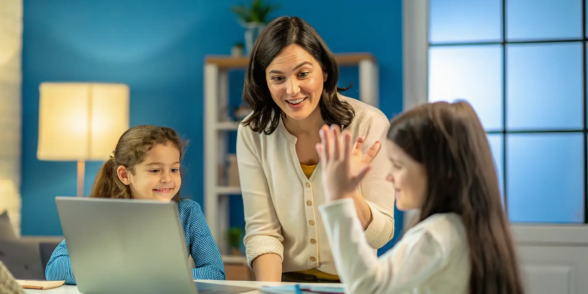 A bilingual teacher coaching two students during a live online class
