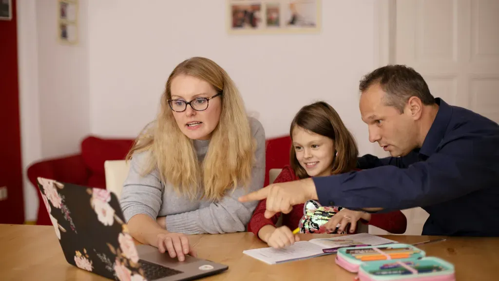 Parent and child using a laptop for online school funded by education savings account