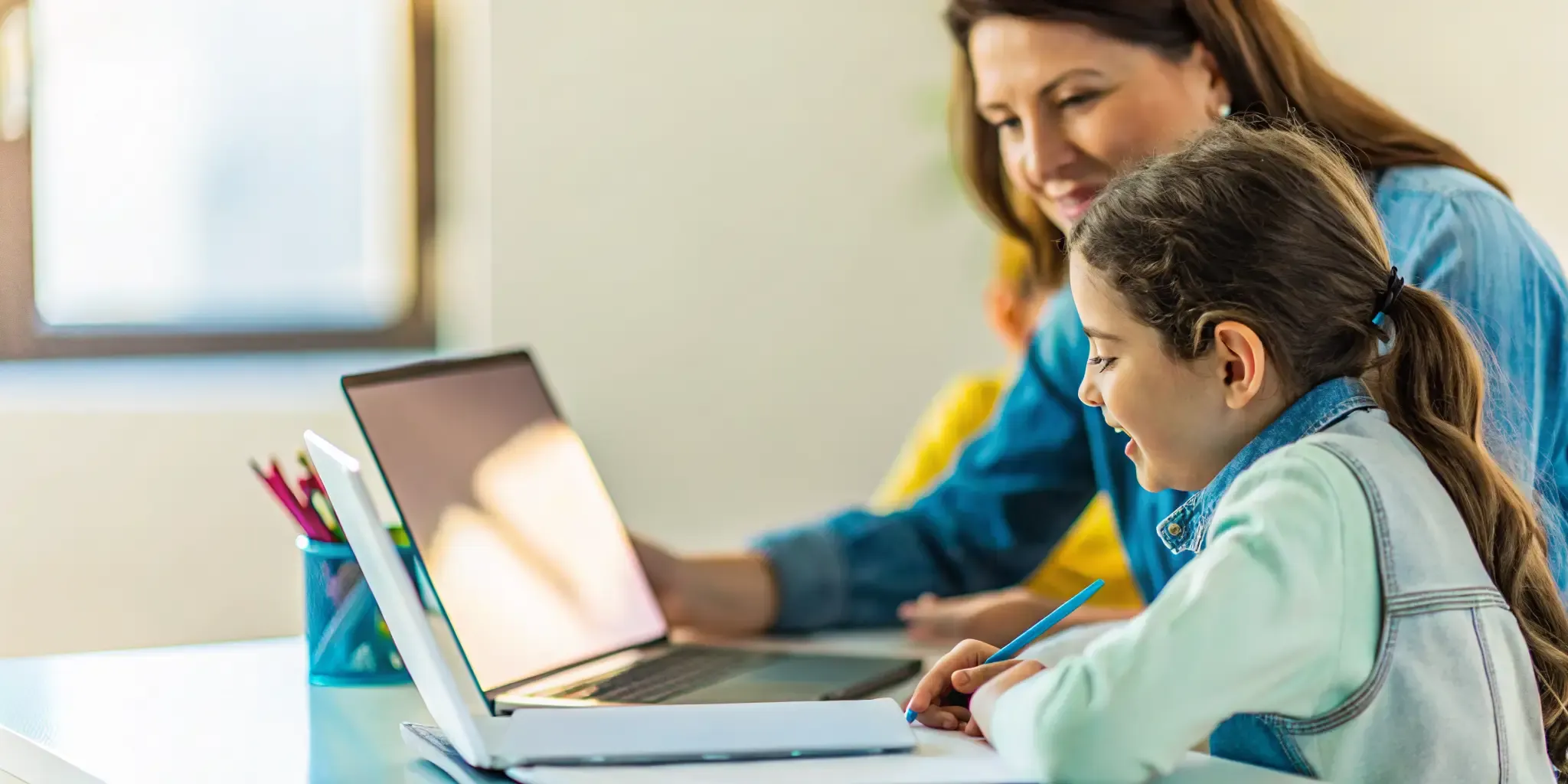 A parent and student reviewing progress together during an online school day