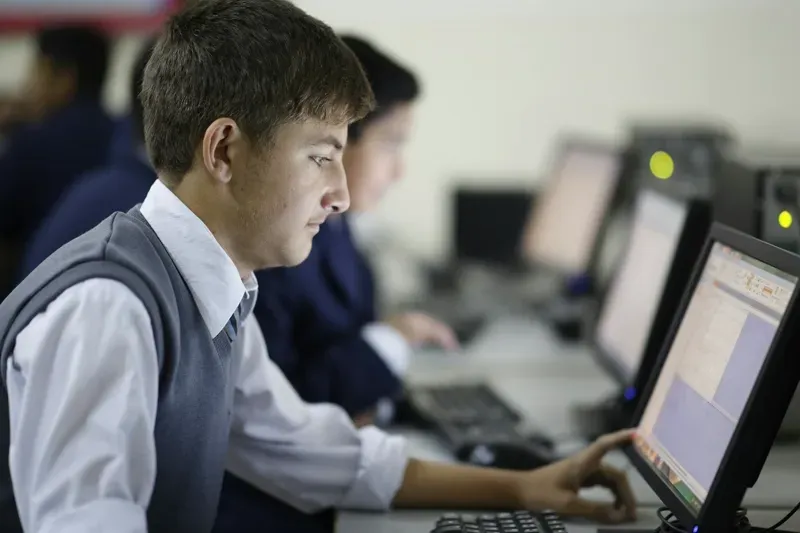 Student developing digital skills while working on a computer in an online learning environment