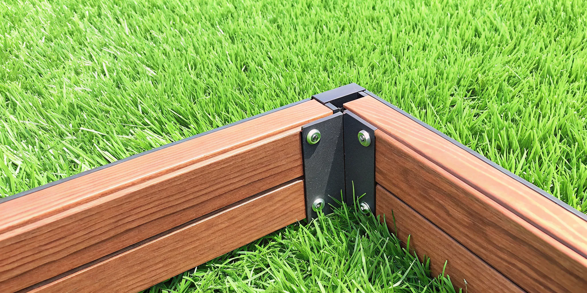 Close-up of a composite fence panel showing realistic wood grain texture and the Snap-Lock connection system