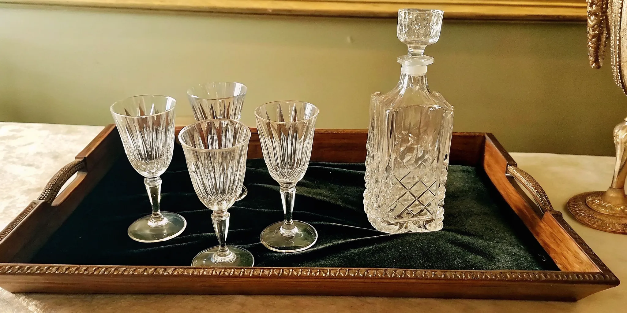 Vintage Waterford crystal stemware and cut crystal decanter arranged on a velvet surface, showing the intricate diamond and fan cut patterns that distinguish authentic pieces